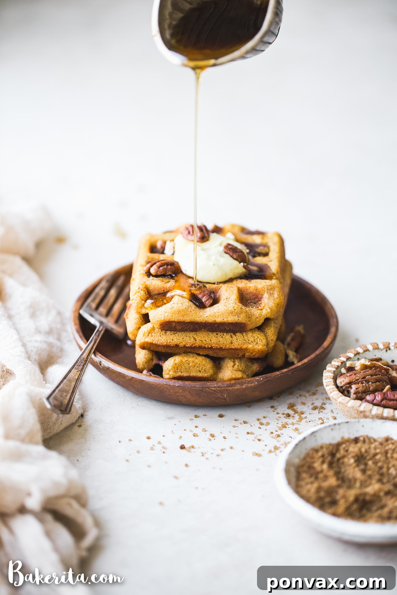Make-Ahead Gluten-Free Vegan Pumpkin Waffles 2 Golden brown Gluten-Free Vegan Pumpkin Waffles with a crispy edge and soft center, perfect for a cozy breakfast.