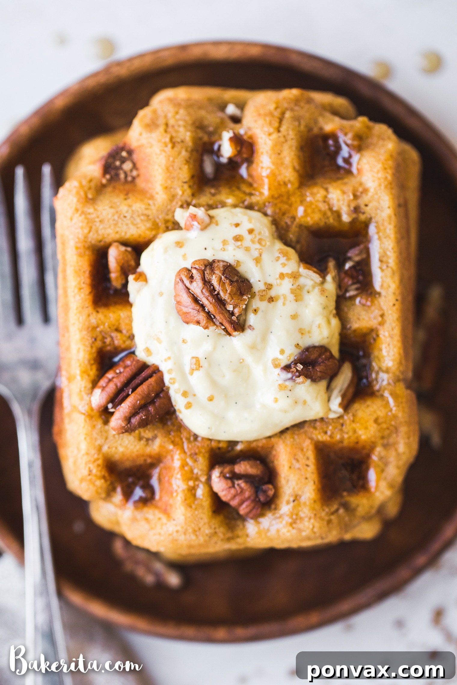 Make-Ahead Gluten-Free Vegan Pumpkin Waffles 3 Close-up of golden Gluten-Free Vegan Pumpkin Waffles drizzled with maple syrup, showcasing their fluffy texture.