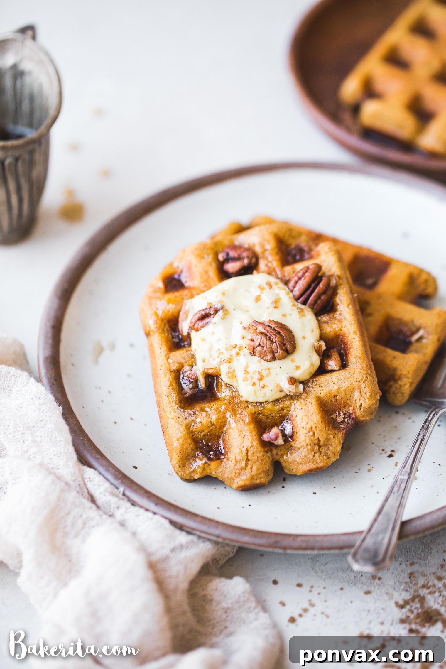 Make-Ahead Gluten-Free Vegan Pumpkin Waffles 5 Four perfectly cooked Gluten-Free Vegan Pumpkin Waffles stacked on a plate, ready for a delicious breakfast spread.