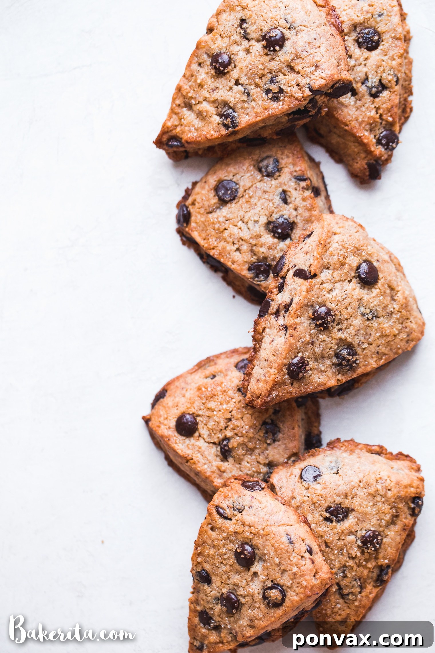 Close-up of a stack of freshly baked vegan gluten-free chocolate chip scones, showing the fluffy texture and melted chocolate chips.