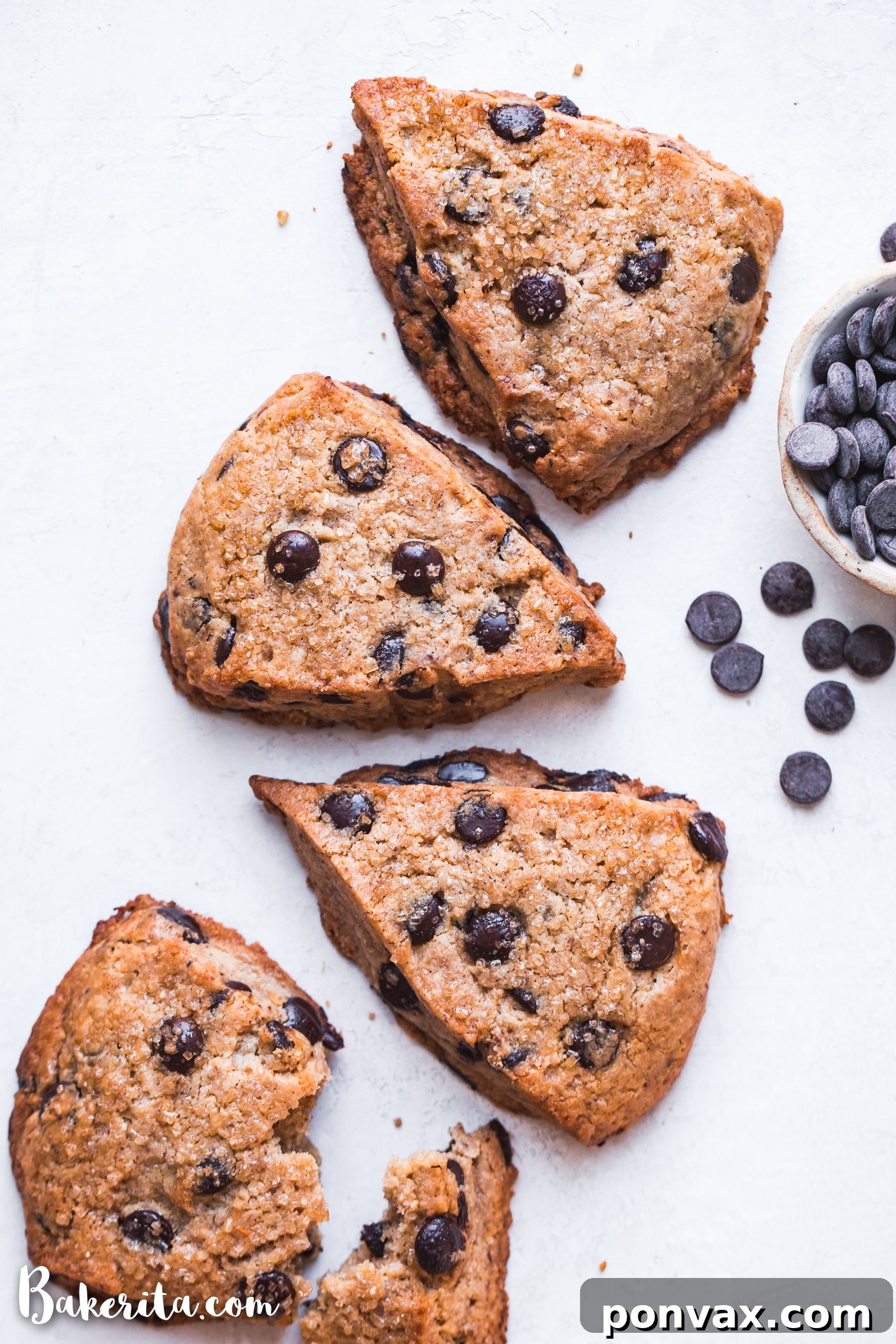 Several vegan gluten-free chocolate chip scones arranged on a baking sheet, ready to be served.