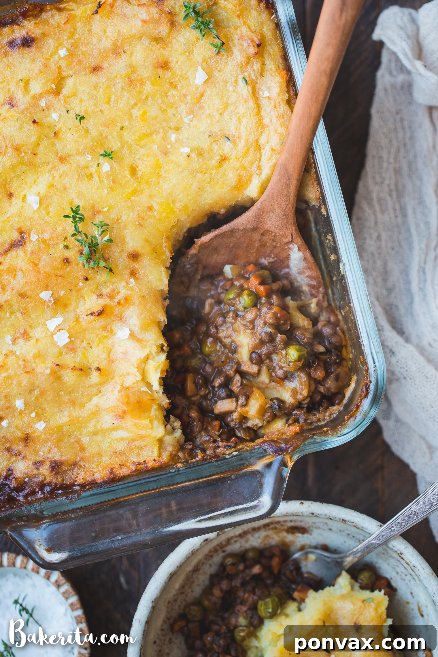 A close-up of Vegan Shepherd's Pie, showcasing the golden mashed potato topping and the hearty lentil and vegetable filling underneath.