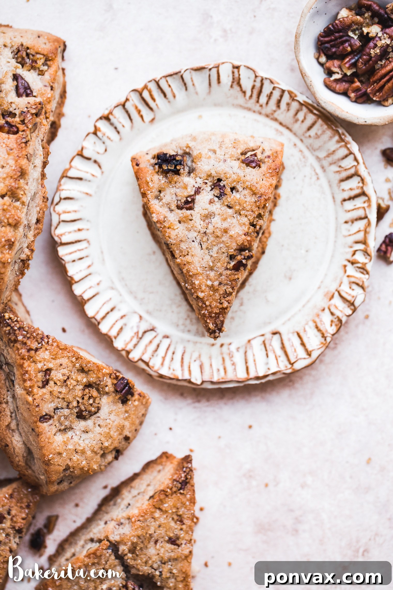 Deliciously Gluten-Free Vegan Maple Pecan Scones 3 Close-up of freshly baked Gluten-Free Vegan Maple Pecan Scones, showing the tender interior and golden-brown exterior, sprinkled with pecans.
