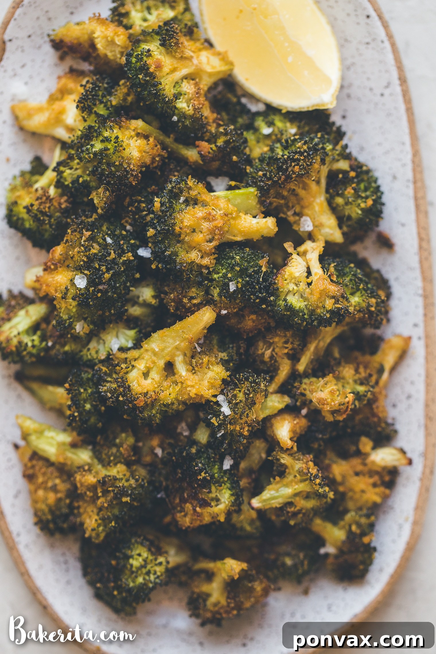 A bowl of roasted broccoli with a light drizzle, showcasing its crispy texture.