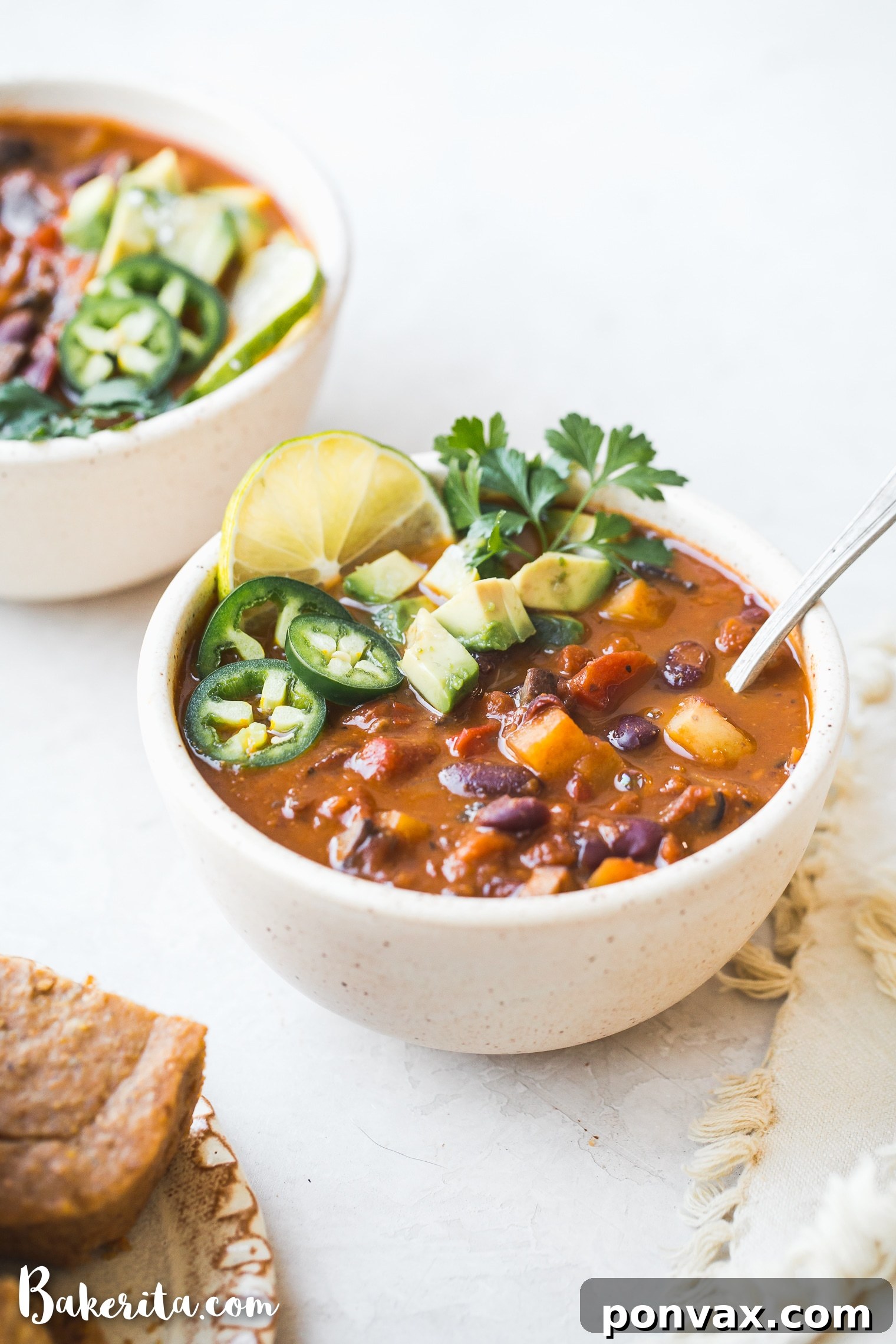 Overhead view of a pot of vegan chili simmering, showing the rich texture and vibrant ingredients.