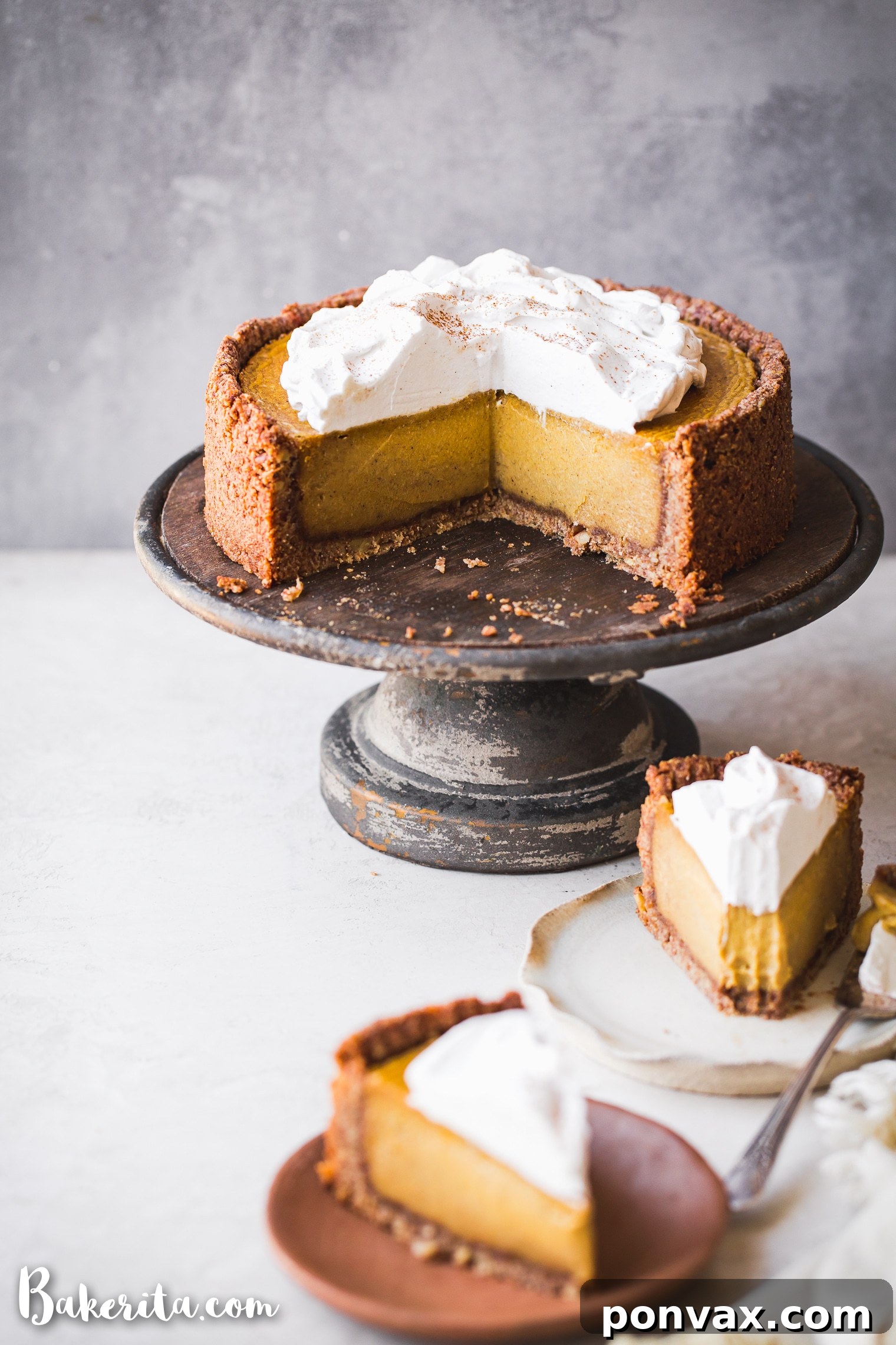 Autumn Glow Vegan Gluten-Free Pumpkin Cheesecake 6 A slice of Baked Vegan Pumpkin Cheesecake topped with a dollop of whipped cream and a sprinkle of cinnamon, ready to be served.