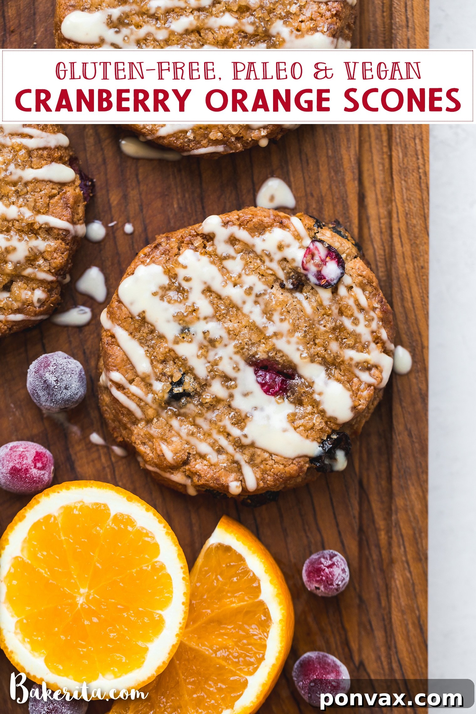 An overhead shot showcasing two freshly baked cranberry orange scones on a wooden surface, garnished with fresh cranberries and orange slices.