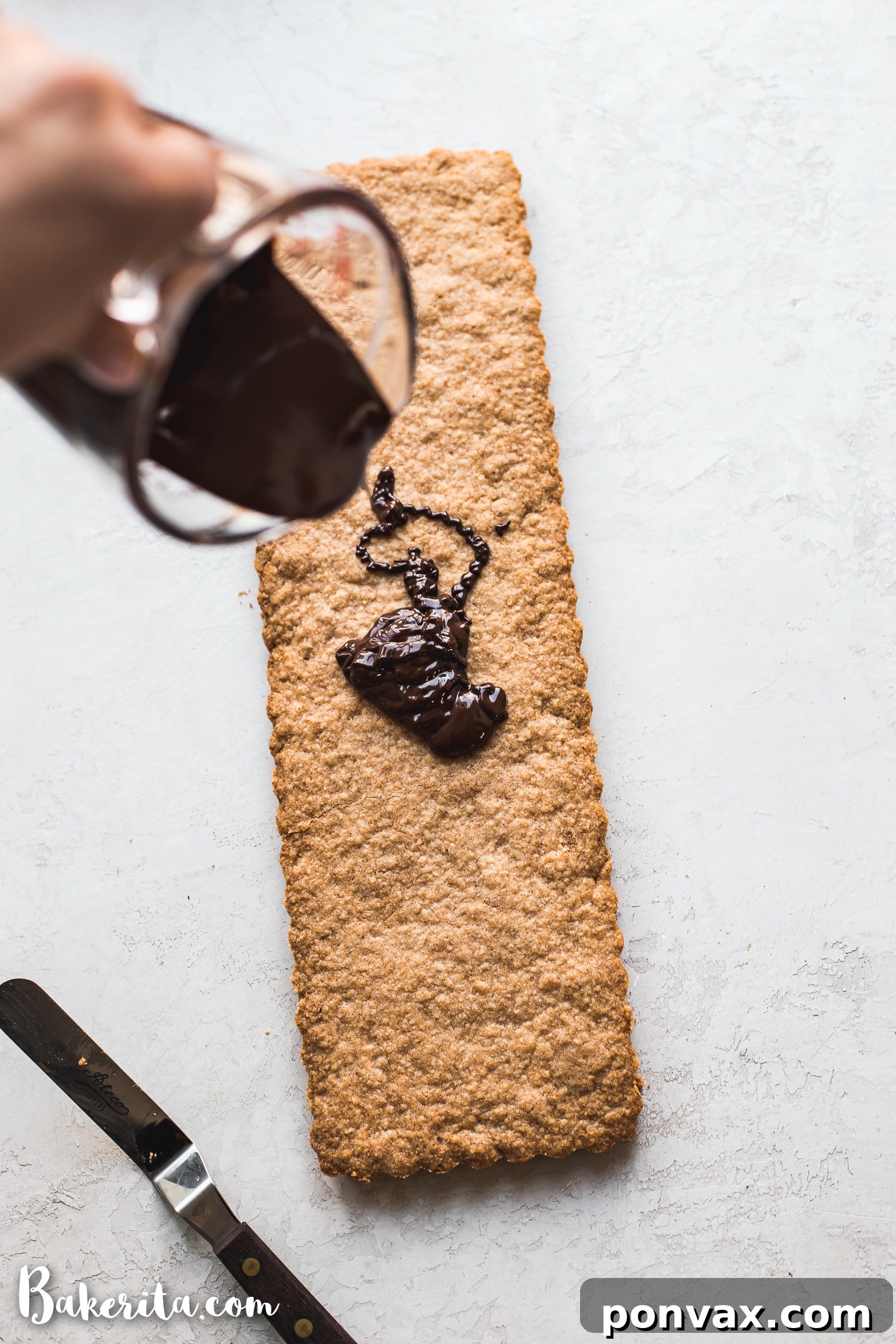 Raw vegan shortbread dough pressed into a square baking pan, ready for chilling.