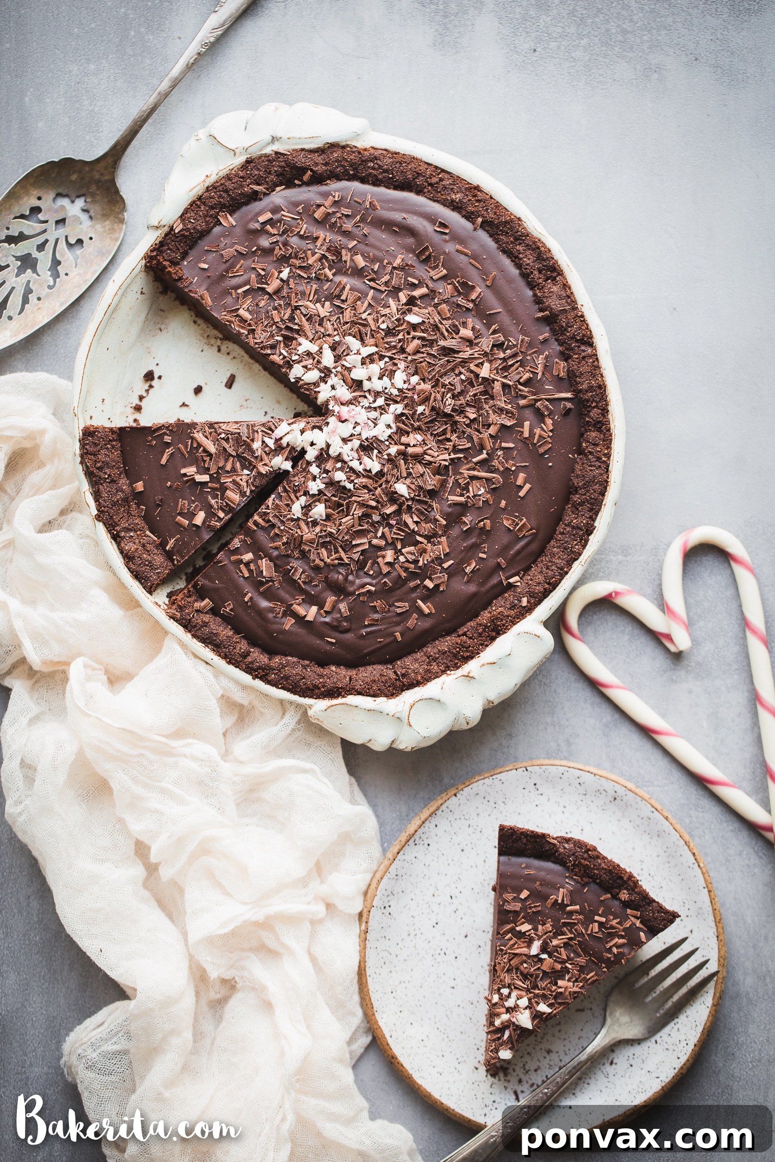 A perfectly sliced Gluten-Free Vegan Chocolate Peppermint Pie, garnished with chocolate shavings and crushed peppermint.