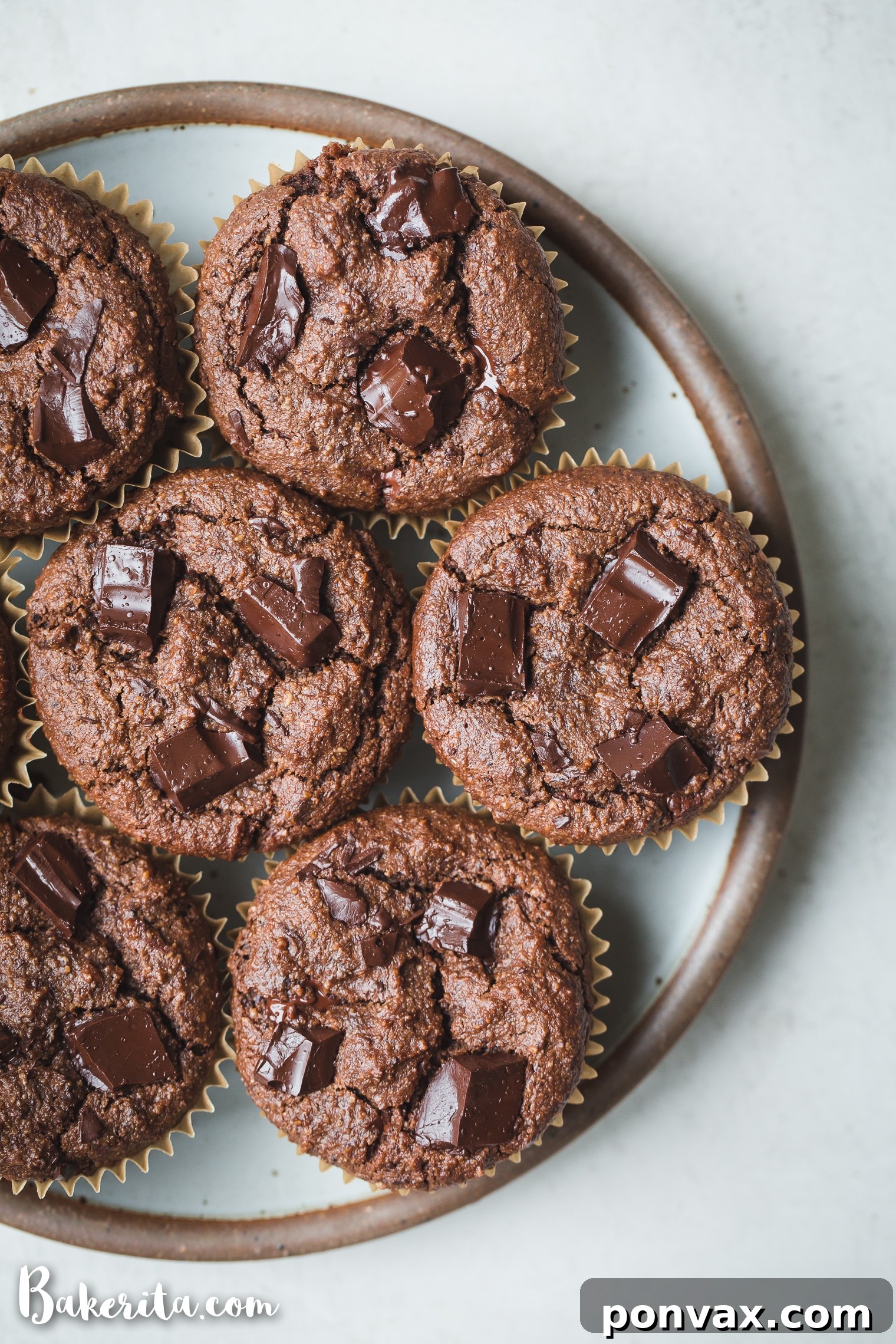 Decadent Gluten-Free Vegan Double Chocolate Muffins 6 Freshly baked Gluten-Free Vegan Double Chocolate Muffins, golden brown and bursting with chocolate.