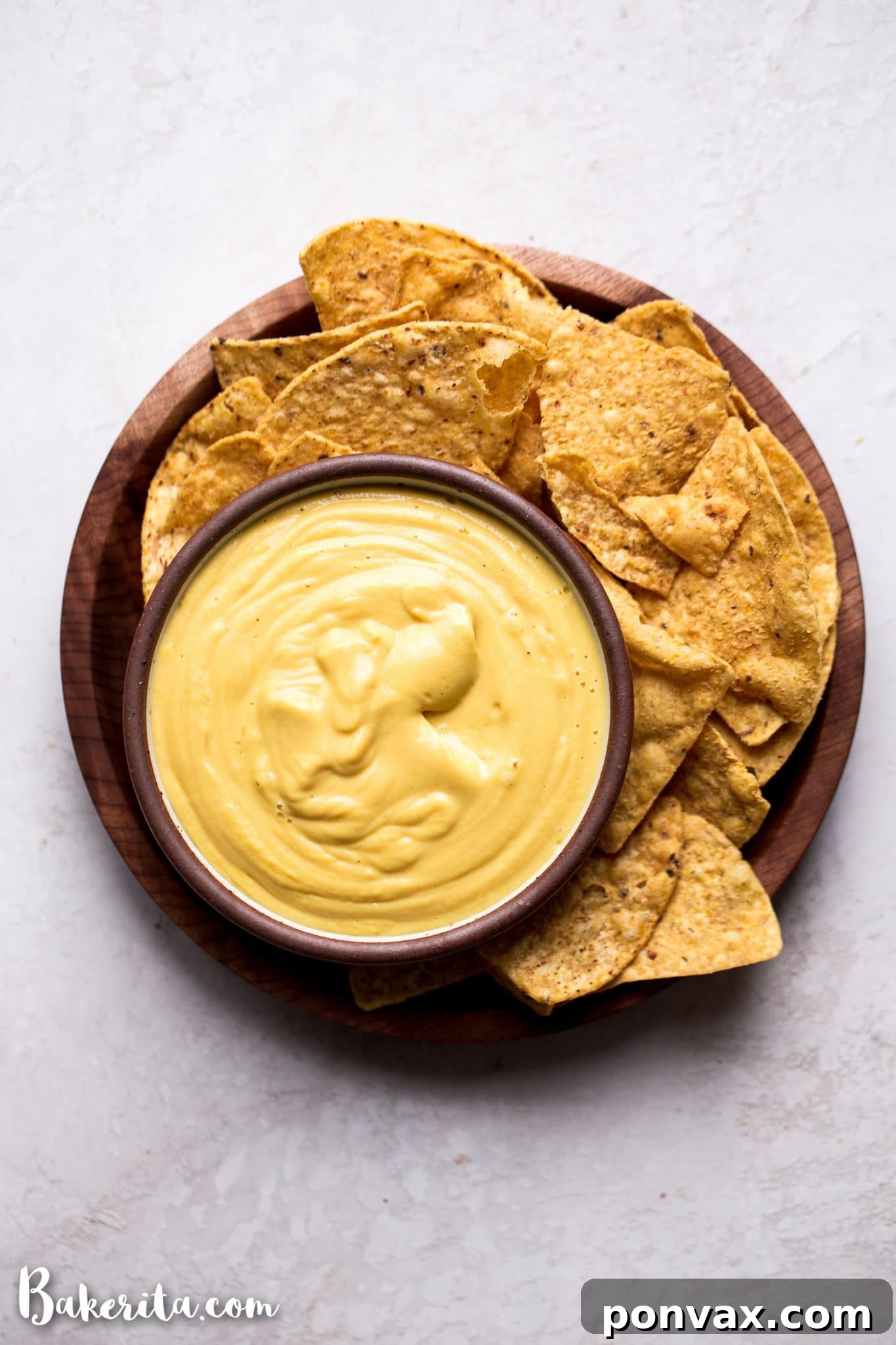 Creamy homemade vegan cheese sauce drizzled generously over a fresh dish, highlighting its rich texture.