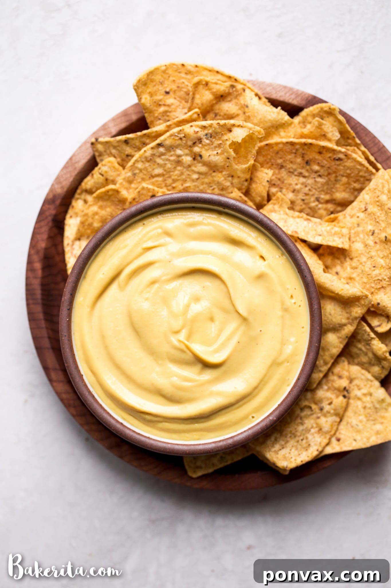 A close-up of a bowl of rich, oil-free, dairy-free vegan cheese sauce, showcasing its vibrant color and smooth consistency.