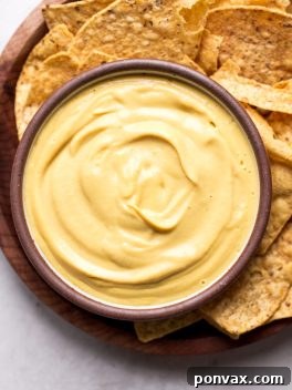 This Vegan Cheese Sauce recipe is easy to make and tastes good on just about everything! It's made with vegetables and cashews for an oil-free, dairy-free cheese sauce. You'll love it with pasta or vegetables, on nachos, and taco bowls, or used as a dip with chips or veggies.