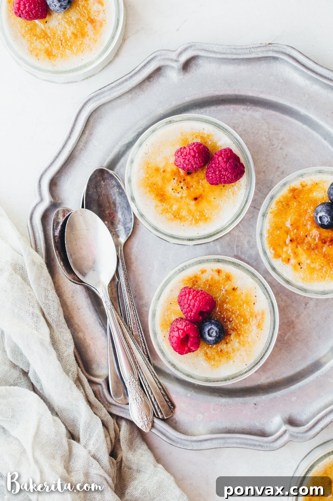 Close-up of a spoonful breaking through the crispy caramelized layer of a homemade Vegan Creme Brulee, revealing the creamy custard.