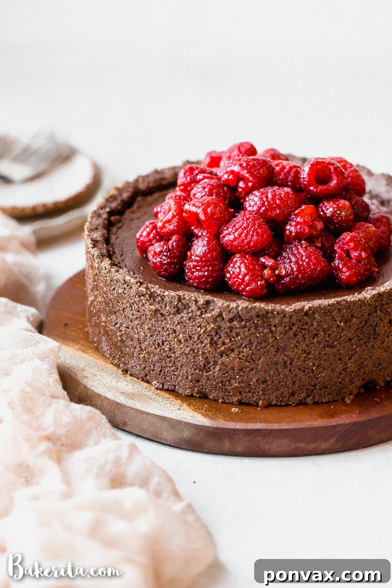 A whole Baked Vegan Chocolate Cheesecake with a gluten-free crust, ready for garnishing, highlighting its smooth, even top.