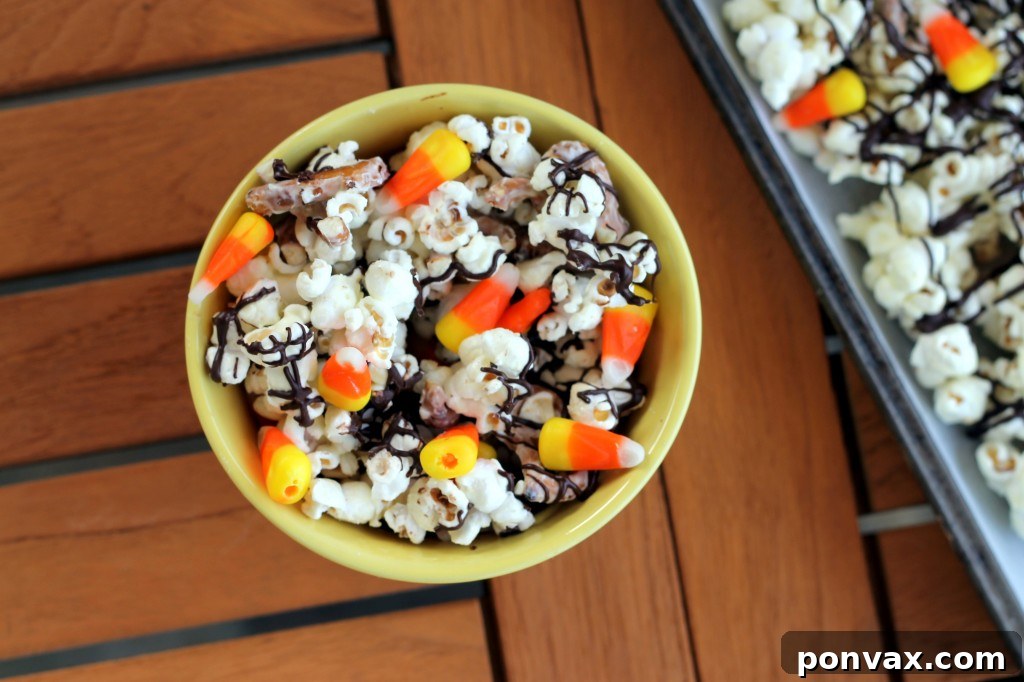 White Chocolate Candy Corn Popcorn Storage This White Chocolate Candy Corn Popcorn is tossed with with pretzels, candy corn, white chocolate, and a drizzle of dark chocolate for a Halloween treat!