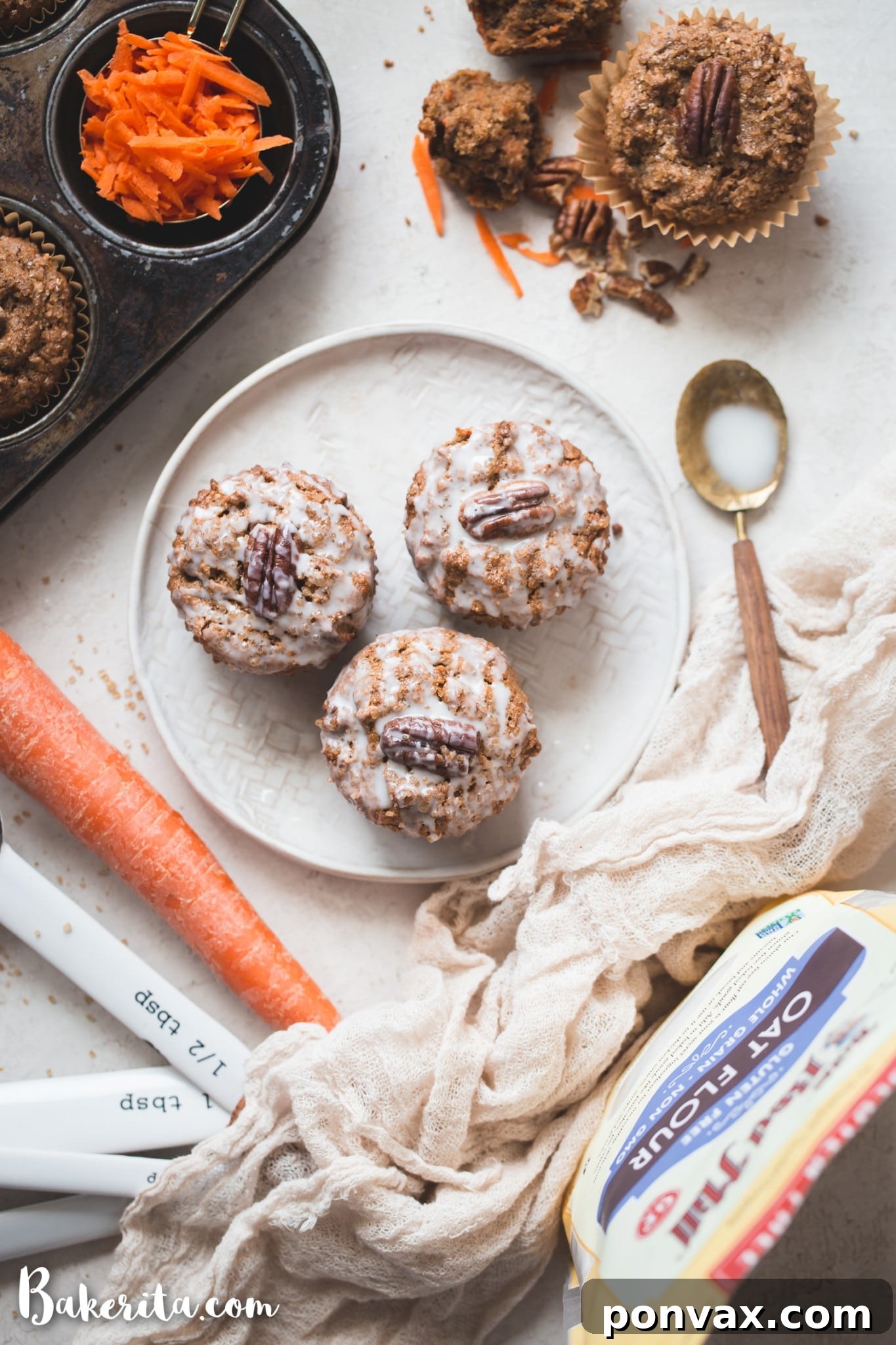 Perfectly Spiced Gluten-Free Vegan Carrot Cake Muffins 6 The vibrant orange shredded carrots and chopped nuts being gently folded into the muffin batter in a large mixing bowl.