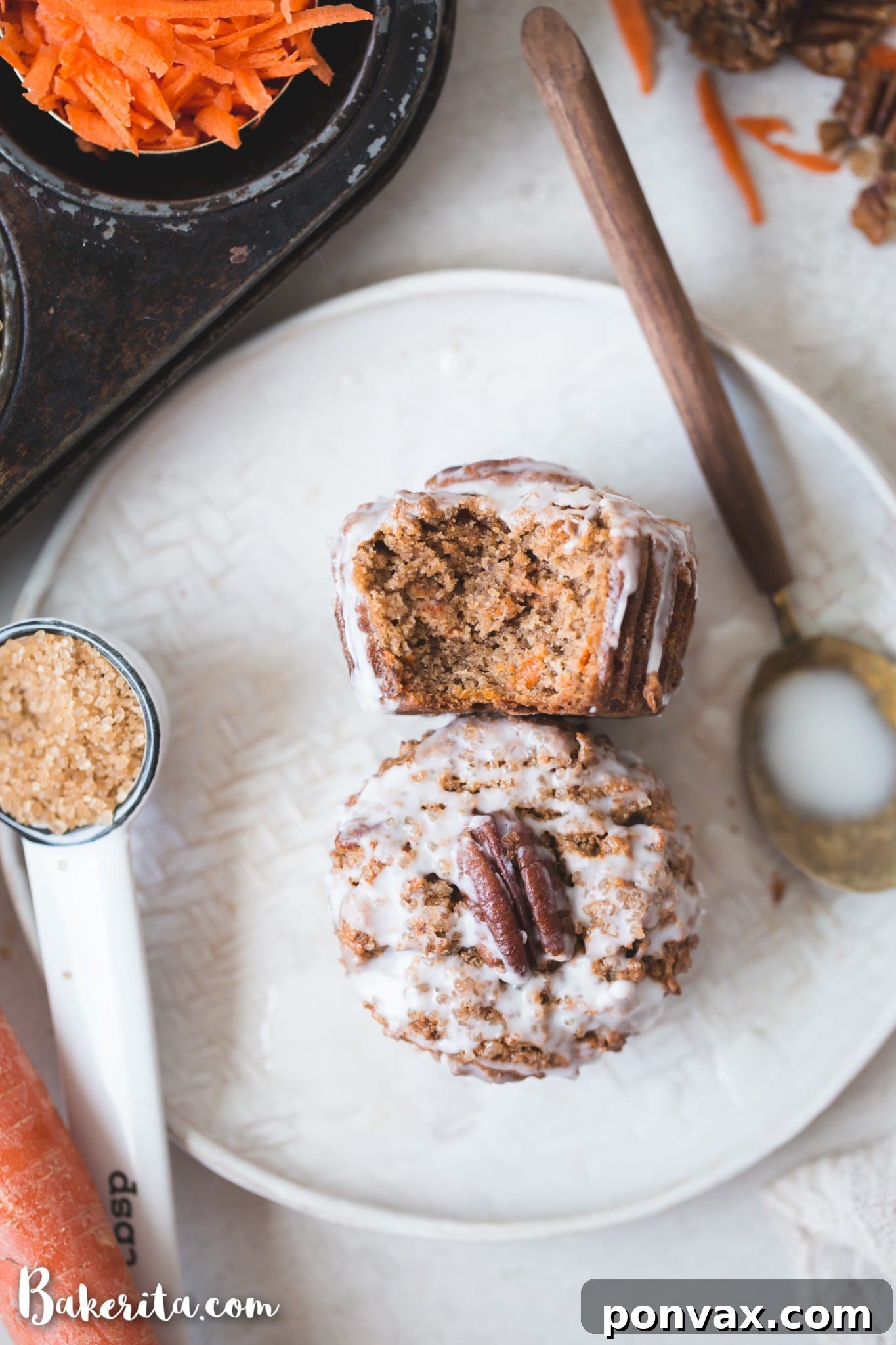 Perfectly Spiced Gluten-Free Vegan Carrot Cake Muffins 7 A serving platter with multiple Gluten-Free Vegan Carrot Cake Muffins, some elegantly drizzled with a simple white glaze, showcasing their appeal as a delicious treat.