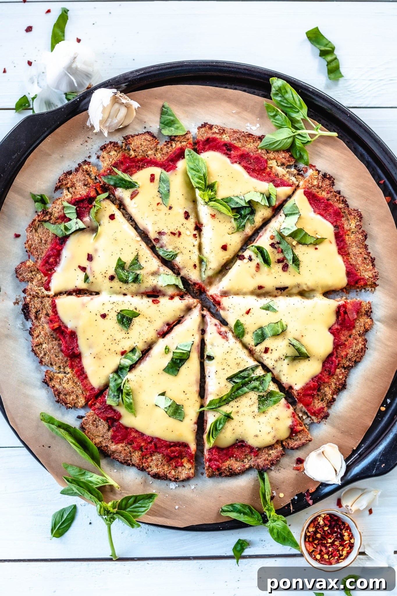 A wholesome Vegan Cauliflower Pizza featuring a crispy crust and topped with rich homemade mozzarella cheeze.