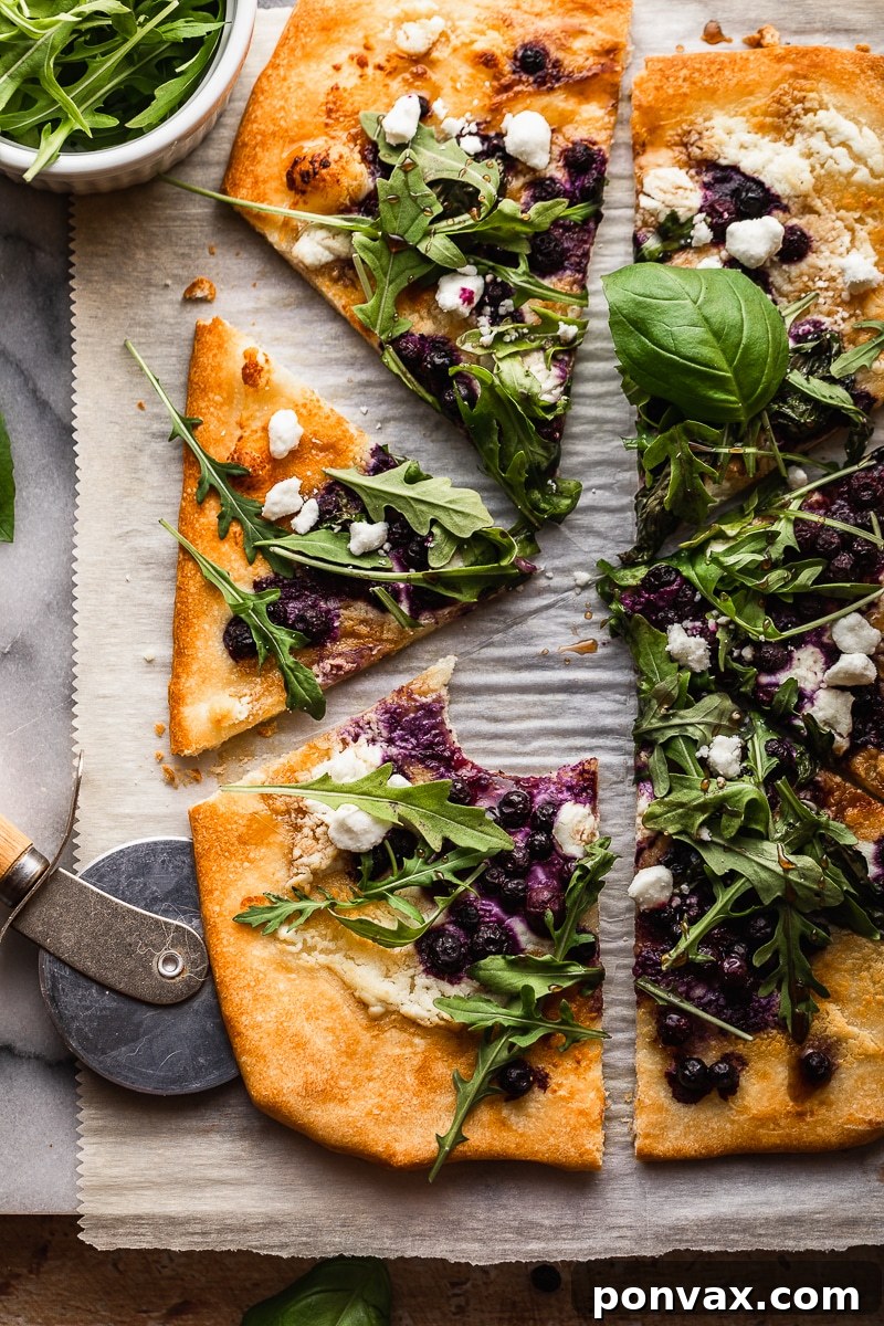 A gourmet Gluten-Free Blueberry Balsamic Goat Cheese Pizza, showcasing fresh blueberries and a balsamic drizzle on a crispy crust.