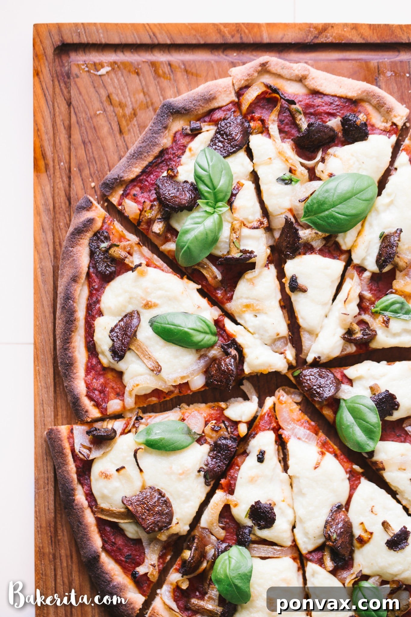 Close-up of creamy homemade vegan mozzarella cheese in a bowl, ready to be spread onto the pizza crust.