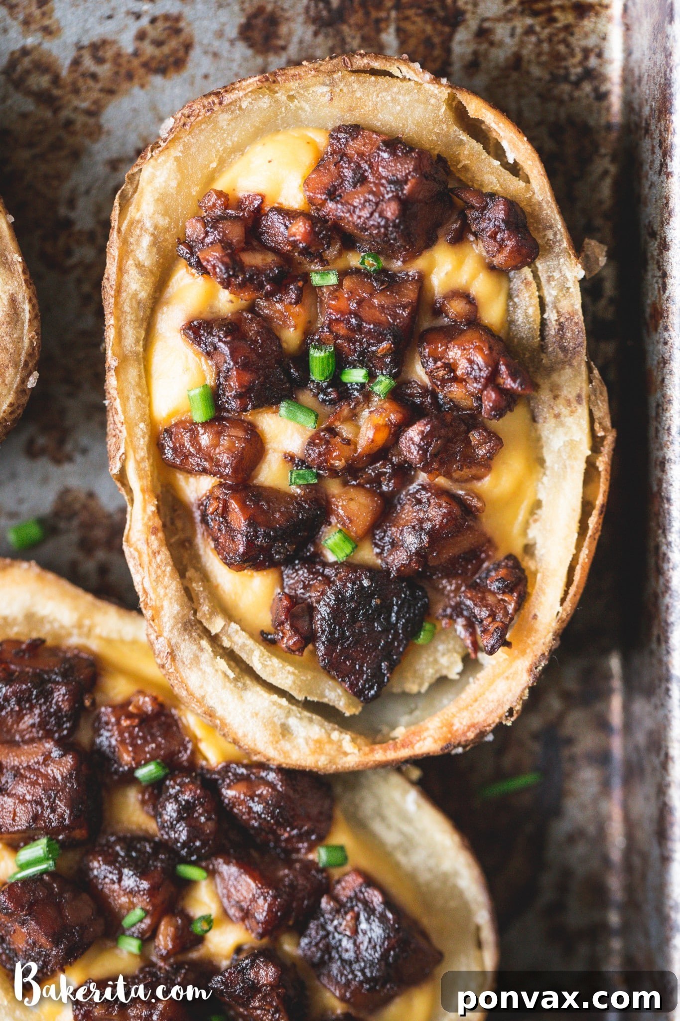 Finished vegan potato skins garnished with fresh chives, ready to be served as an appetizer.