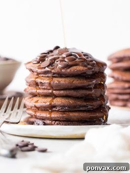 These Gluten-Free Vegan Double Chocolate Pancakes are a deliciously fluffy and decadent breakfast! Made with rolled oats and loaded with chocolate chips.