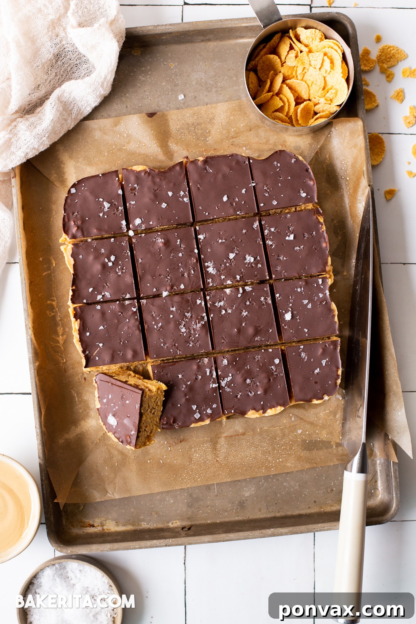 Close-up of a stack of homemade peanut butter cornflake bars, showing the crunchy texture and chocolate topping.