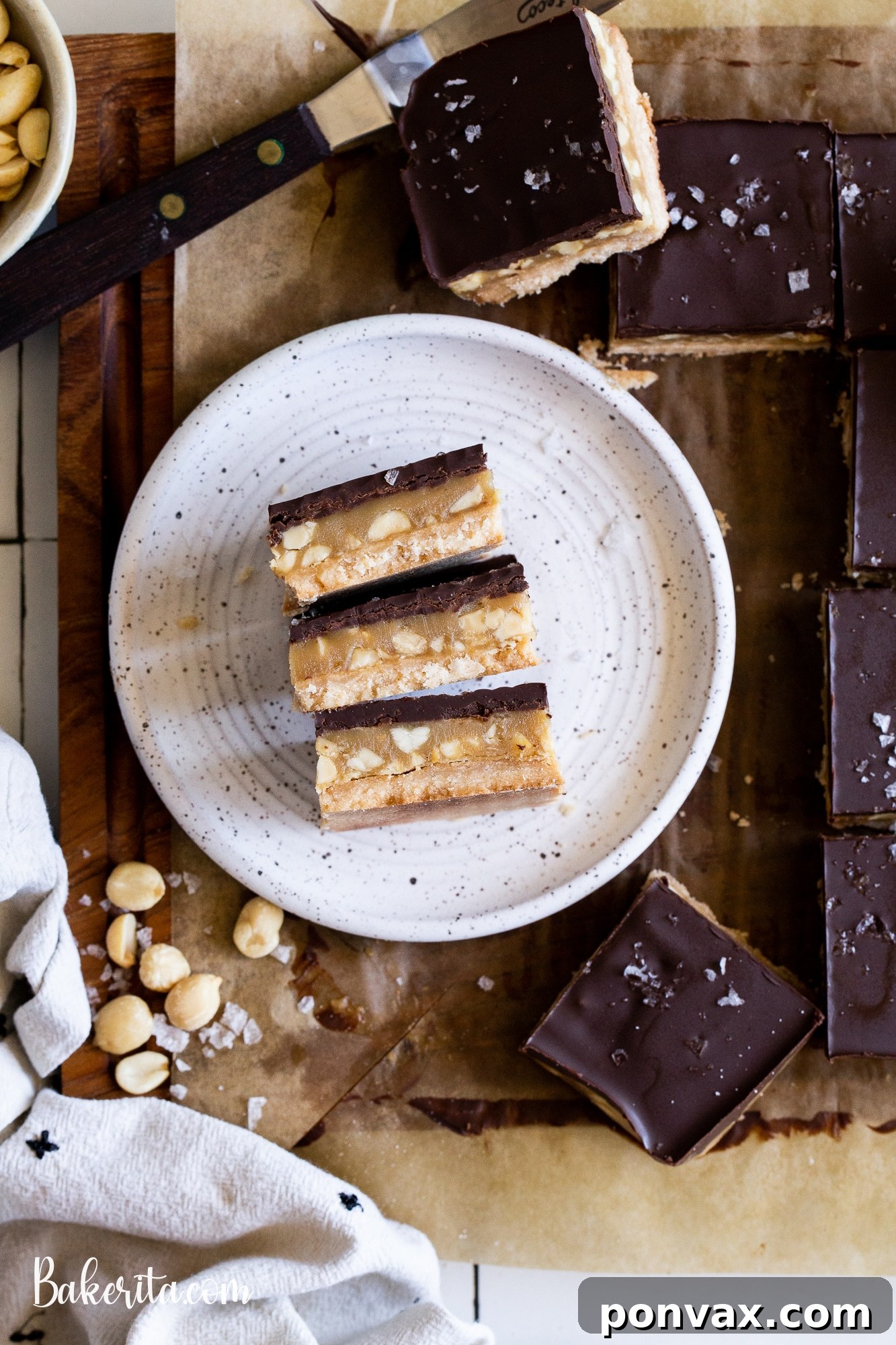 Decadent Vegan Peanut Butter Millionaire's Shortbread 2 Irresistible Gluten-Free Vegan Peanut Butter Millionaire's Shortbread bars with layers of shortbread, peanut butter caramel, and chocolate.