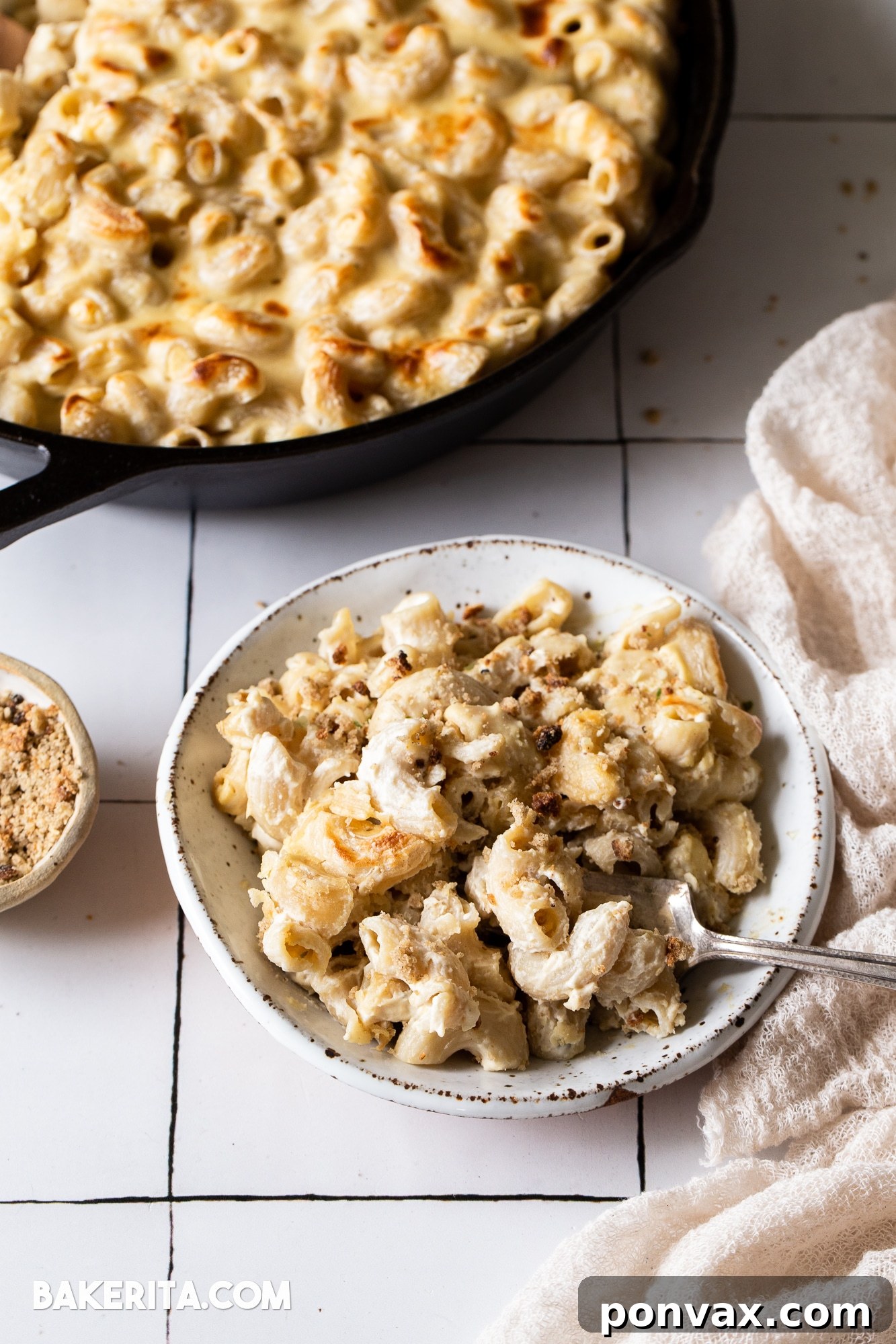 A close-up of a serving of baked vegan mac and cheese, showcasing the golden, bubbling sauce and perfectly cooked noodles, ready to be devoured.
