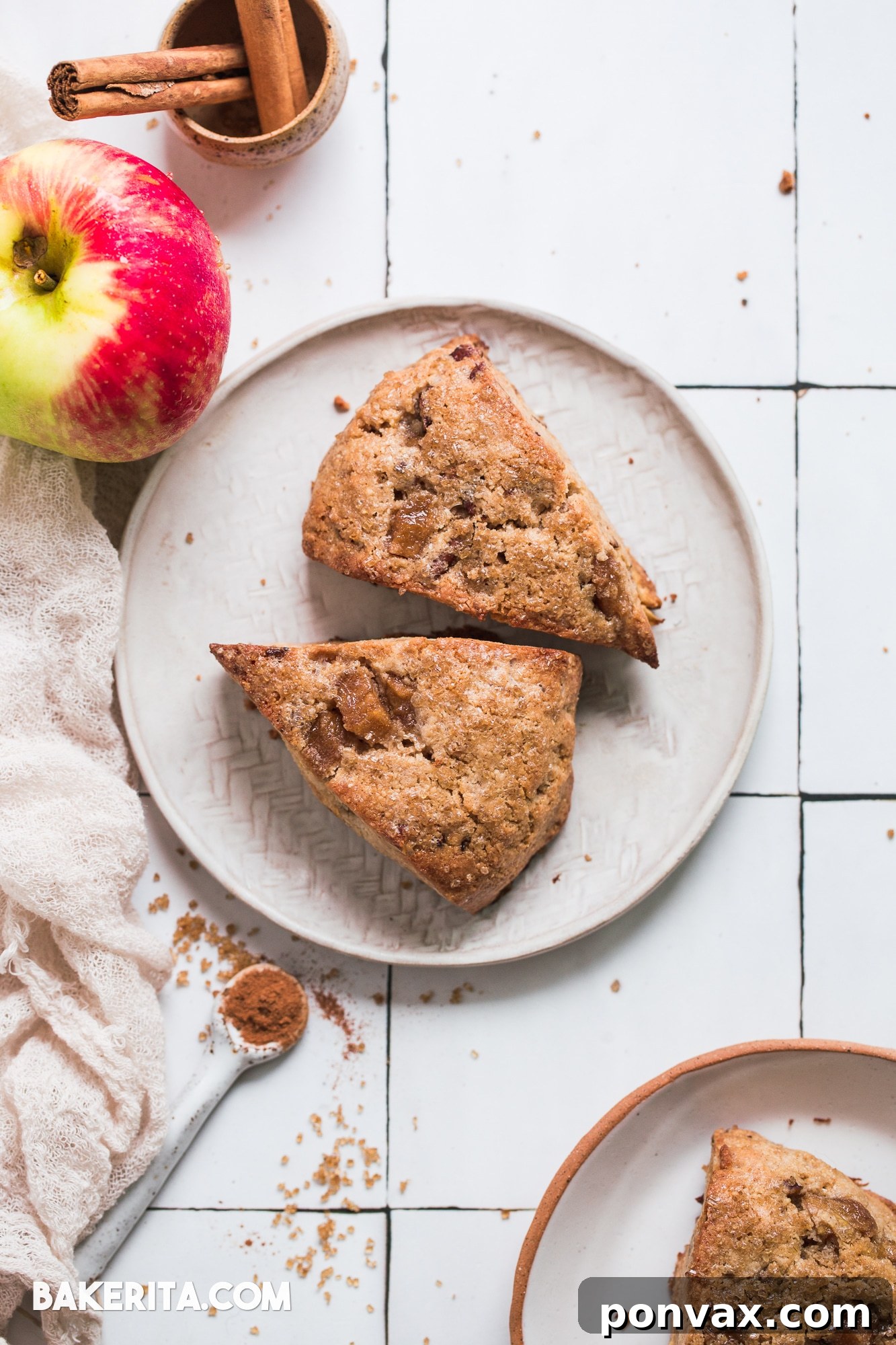 Freshly baked Gluten-Free Vegan Apple Cinnamon Scones on a cooling rack, showcasing their golden-brown tops and flaky texture. A perfect fall treat for breakfast or dessert.