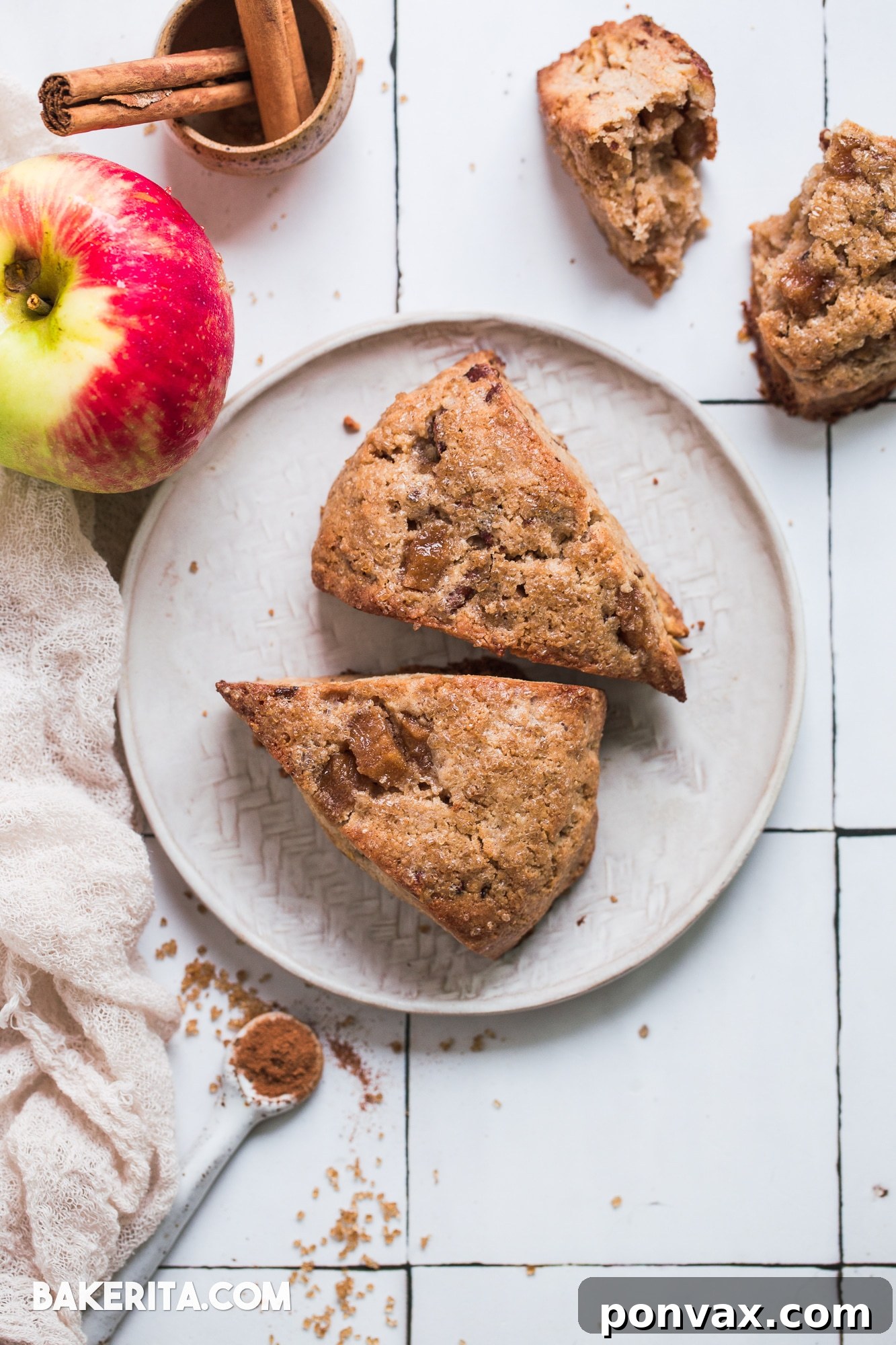 Chilled scone dough cut into eight wedges on parchment paper, ready for baking. Sprinkled with Turbinado sugar.
