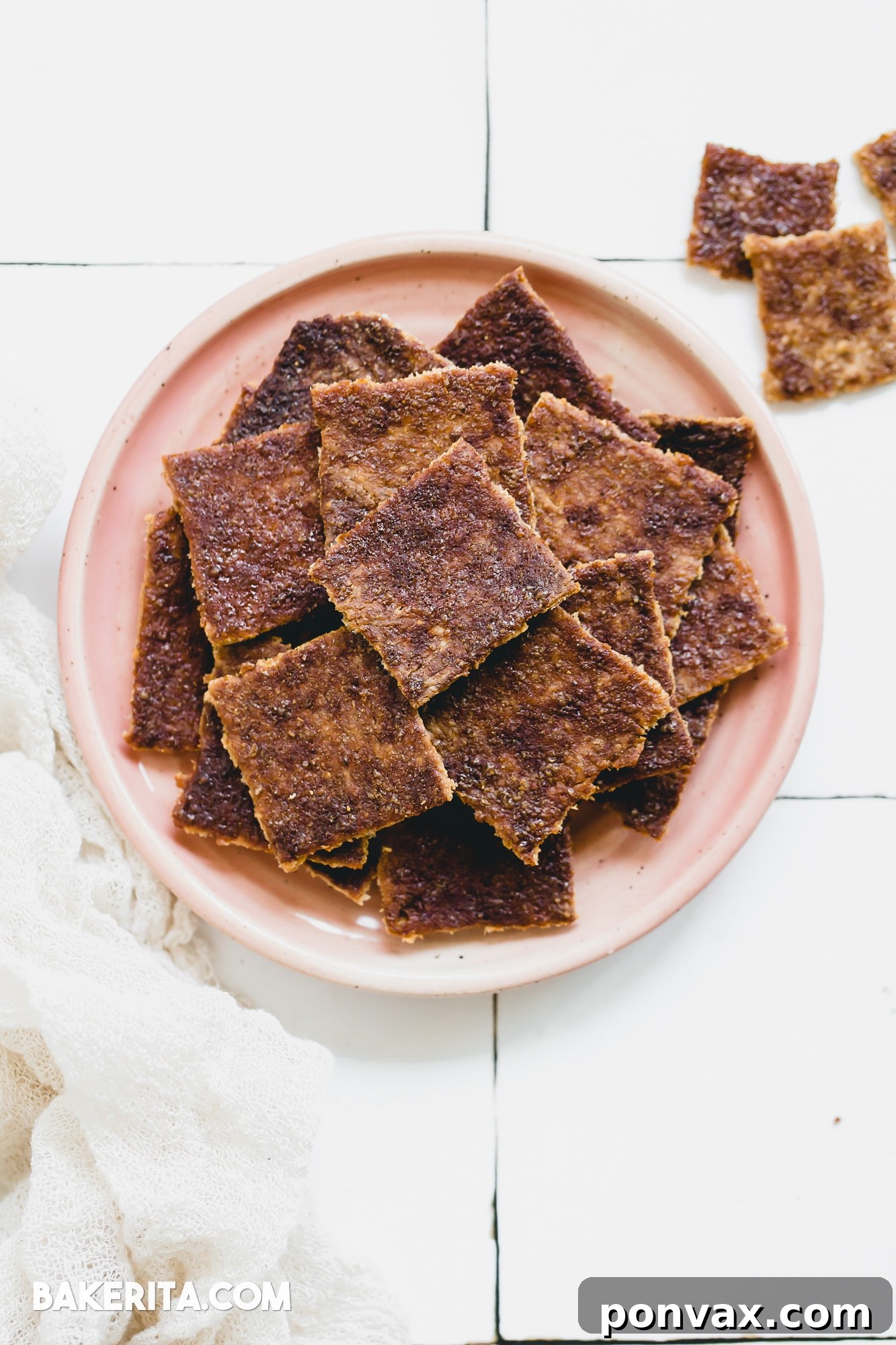 Spiced Gluten-Free Sourdough Discard Crisps 2 Crispy Gluten-Free Cinnamon Sugar Sourdough Discard Crackers stacked on a wooden board