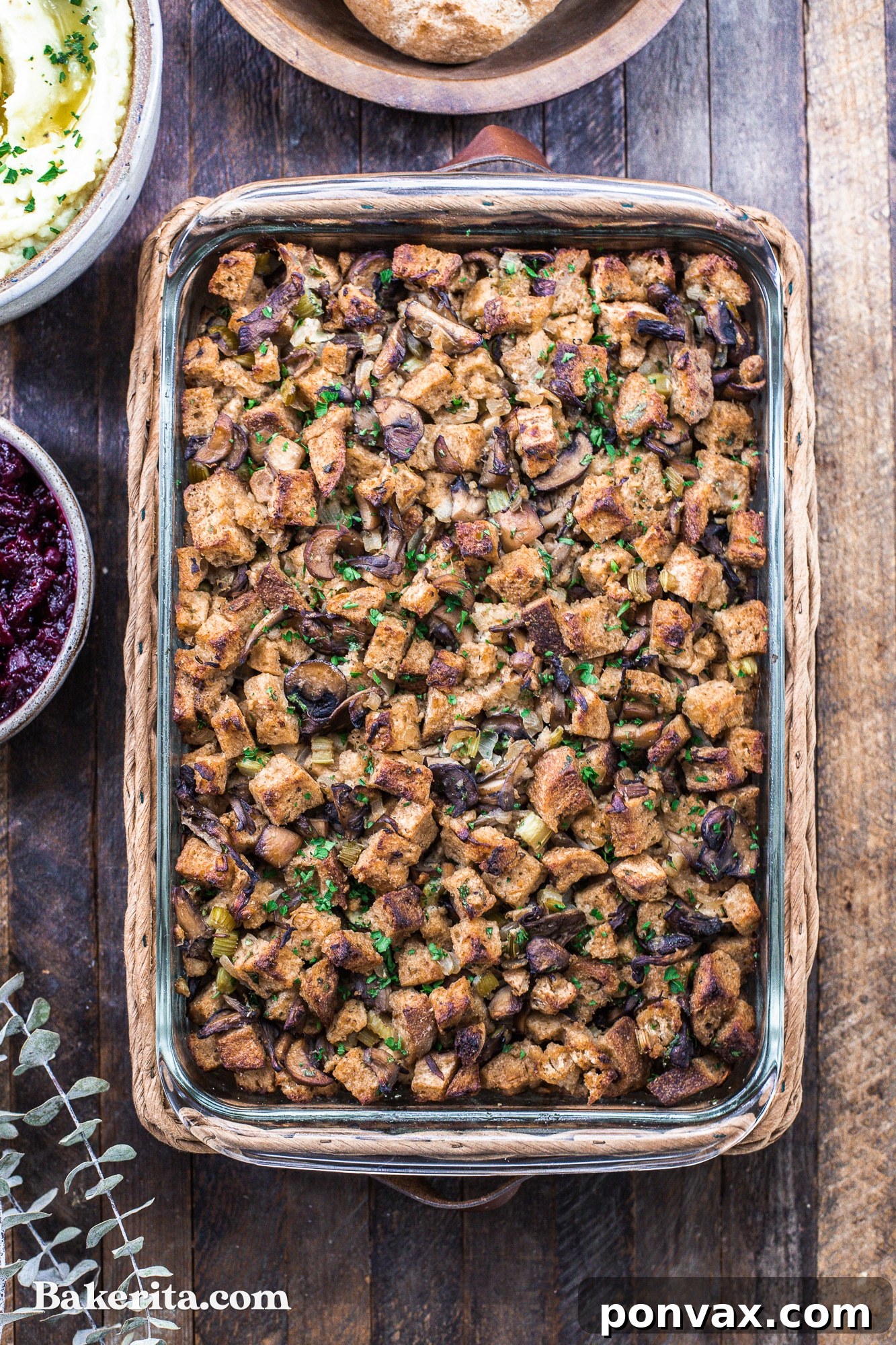 A beautifully baked Vegan Mushroom Stuffing, showcasing a golden-brown crispy top and fresh herb garnish, ready for holiday feasting.