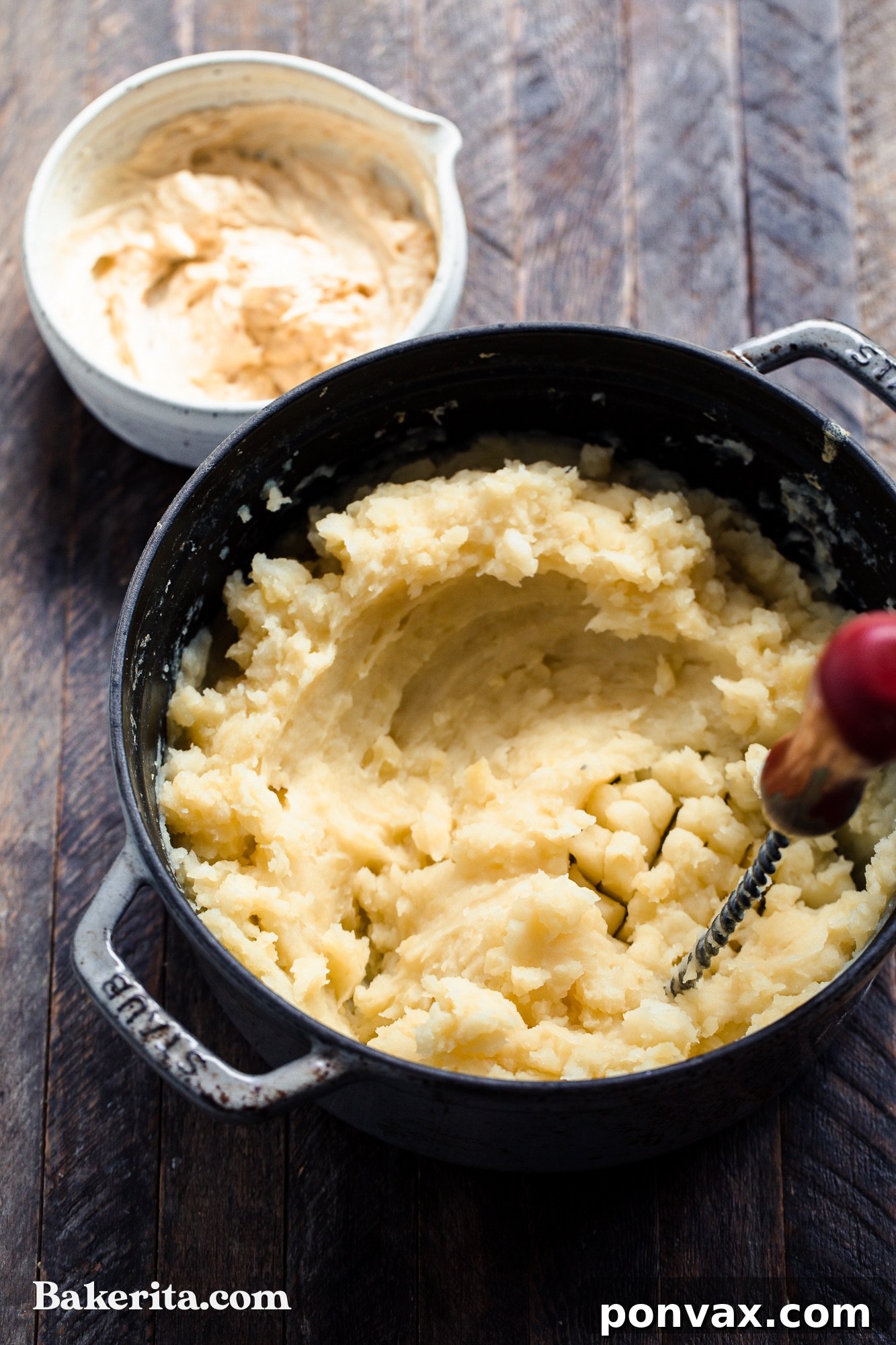 A close-up of creamy vegan mashed potatoes in a white bowl, showing their smooth texture.