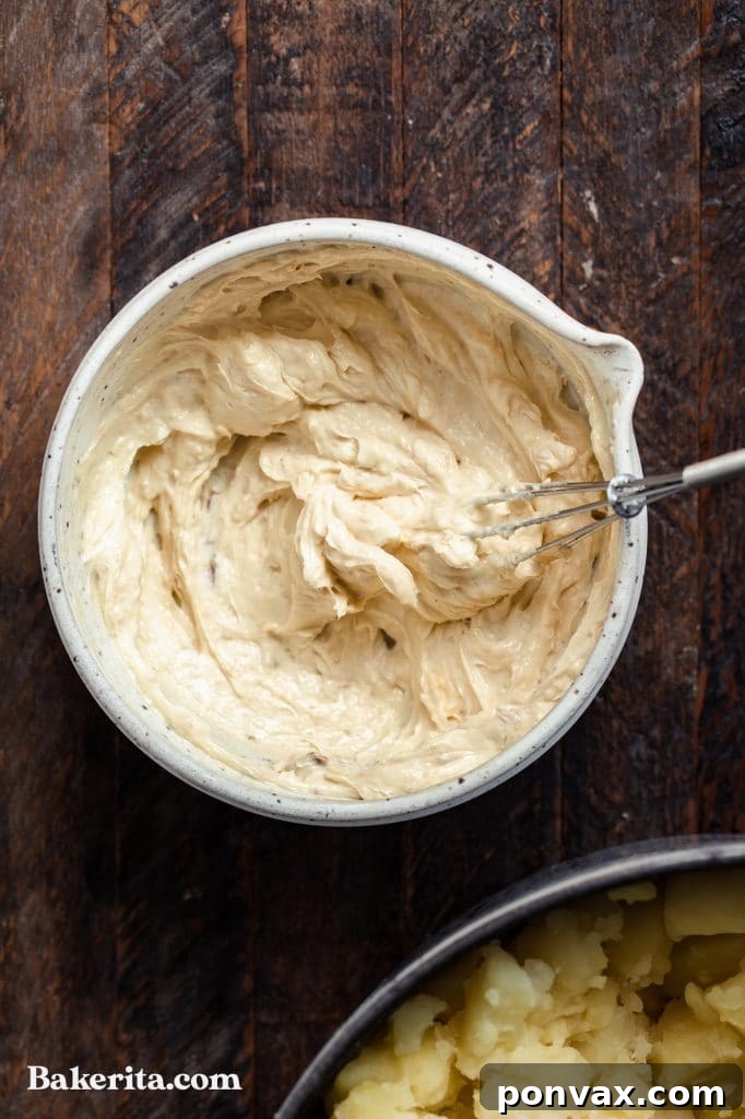 Side view of a bowl of creamy vegan mashed potatoes.