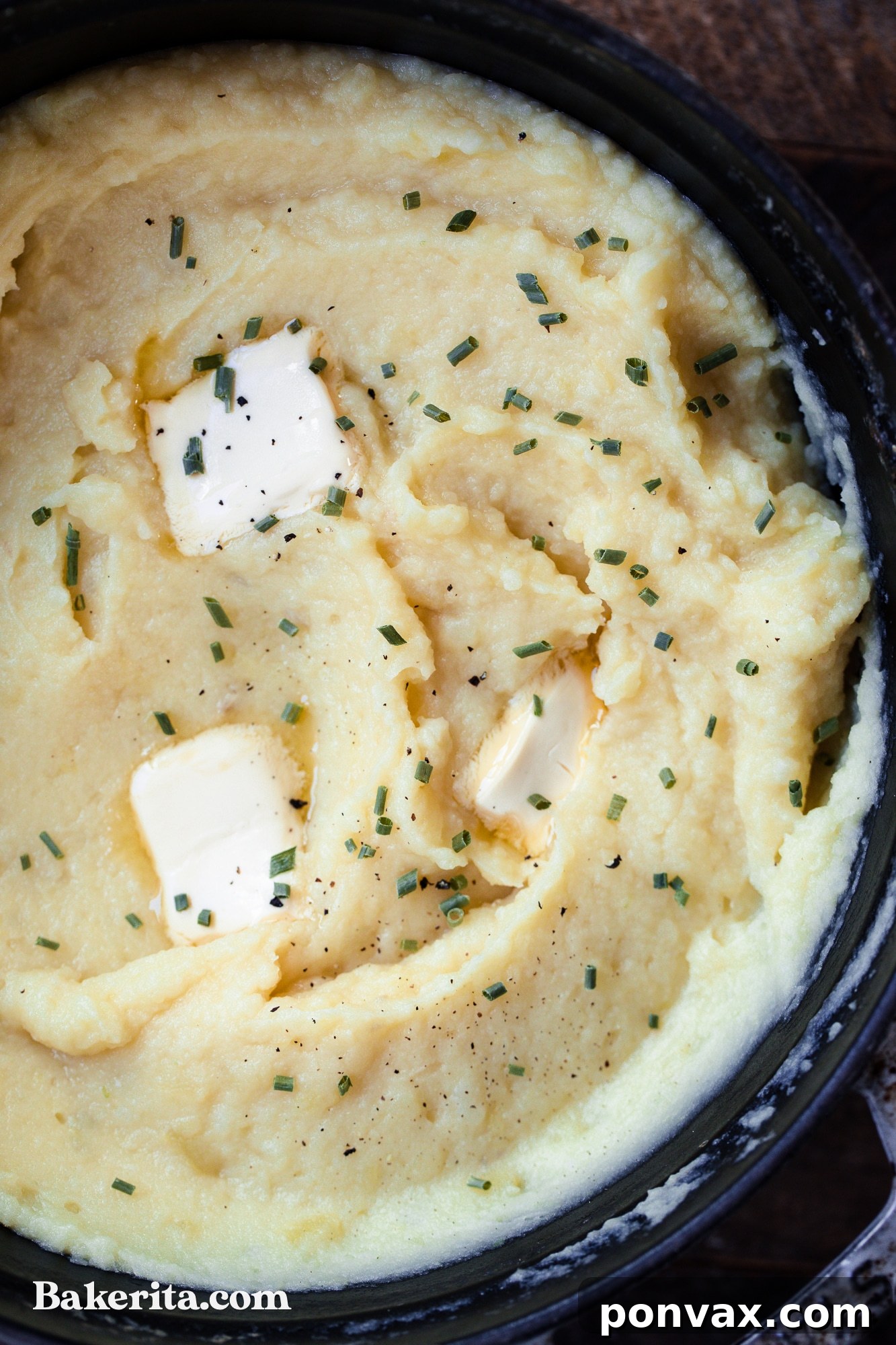 Close up shot of creamy vegan mashed potatoes in a bowl with a fork.