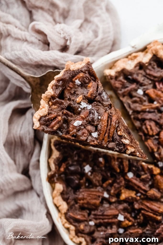 A close-up shot of the rich, dark chocolate and pecan filling of the Vegan Chocolate Pecan Pie.