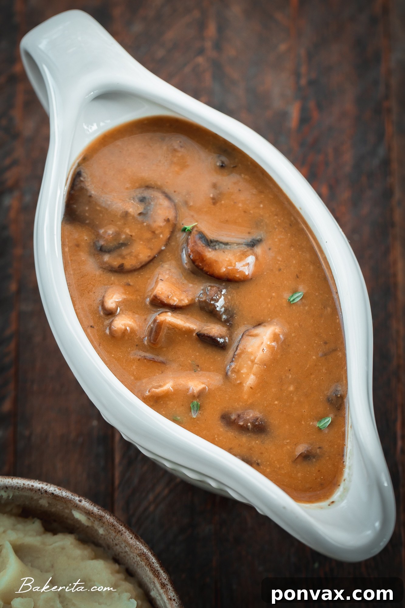 Close-up of rich vegan mushroom gravy in a gravy boat, ready to be served over holiday dishes.