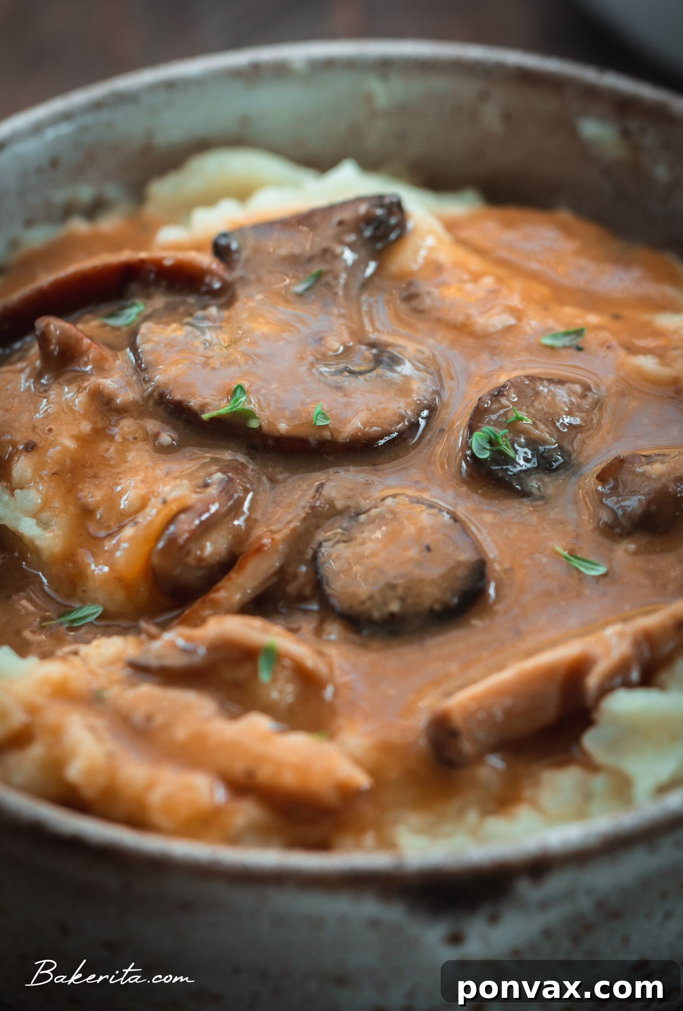 Ingredients for vegan mushroom gravy laid out on a cutting board, including mushrooms, onion, garlic, and spices.