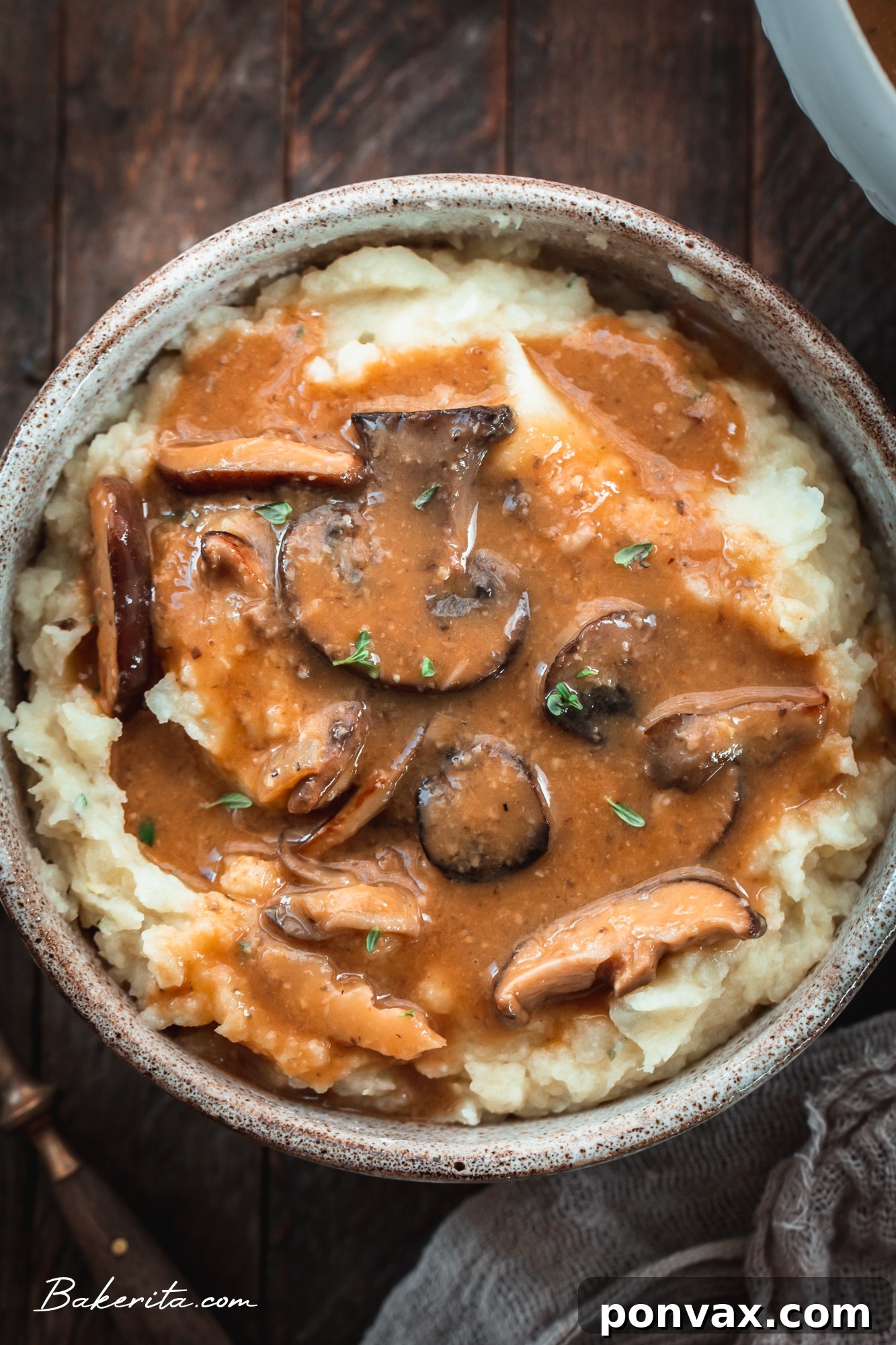 A ladle scooping rich vegan mushroom gravy from a saucepan.