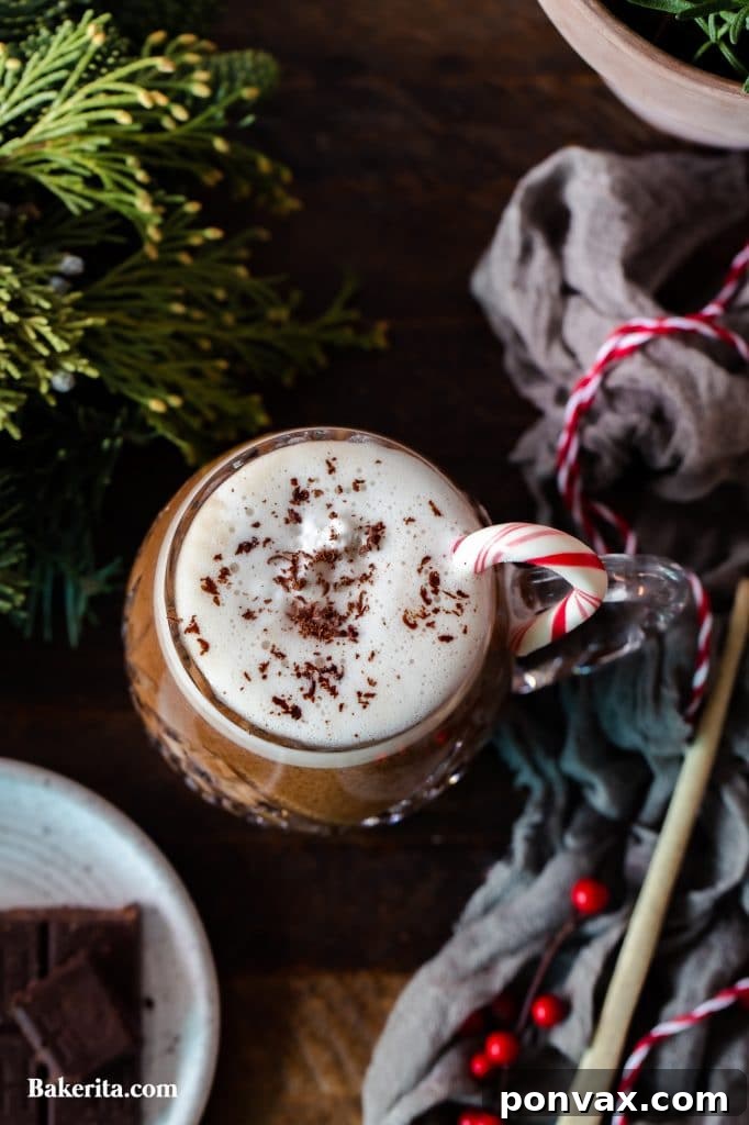 Seasonal Sips: Peppermint Mocha, London Fog, and Salted Cashew Hot Chocolate 6 A London Fog Tea Latte in a mug, garnished.