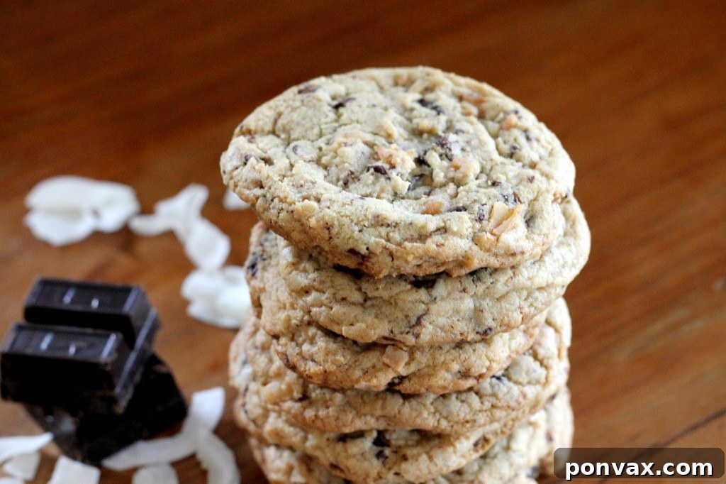 Close-up of a stack of golden brown Caramel Coconut Chocolate Chunk Cookies.