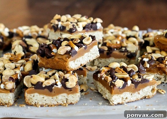 Stacked Flavor Bars 3 A close-up of a hand reaching for a Fully Loaded Bar, highlighting the crumbly crust and gooey toppings.