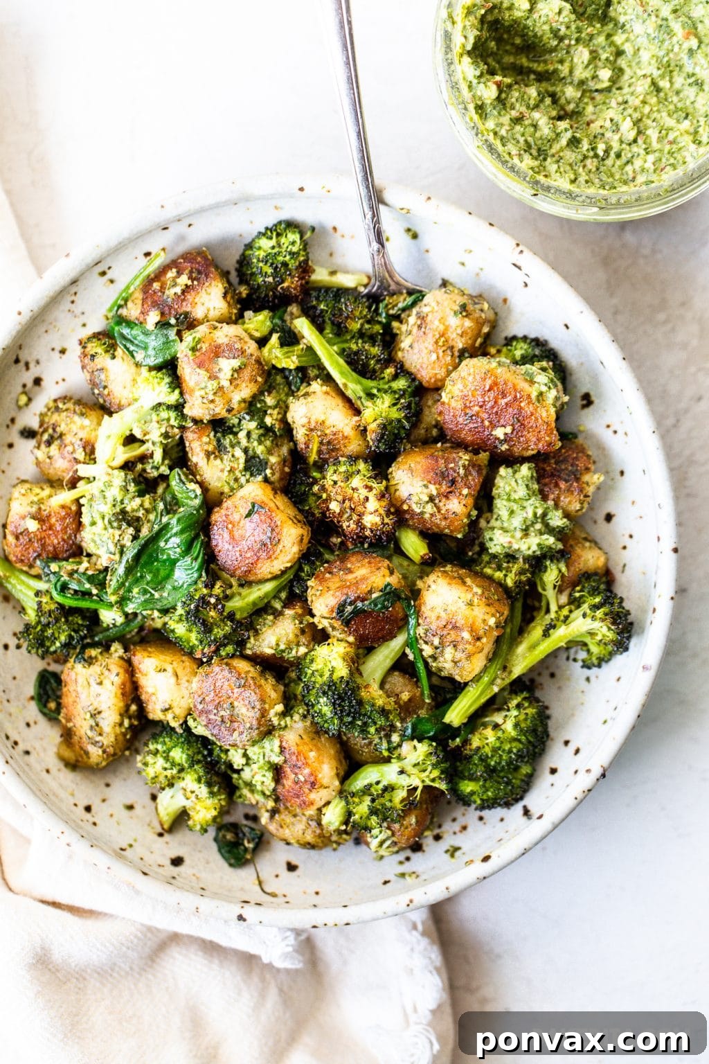 Pillowy Vegan Cauliflower Gnocchi with Fresh Pesto 2 Crispy Vegan Cauliflower Gnocchi with Pesto dish, garnished with fresh herbs