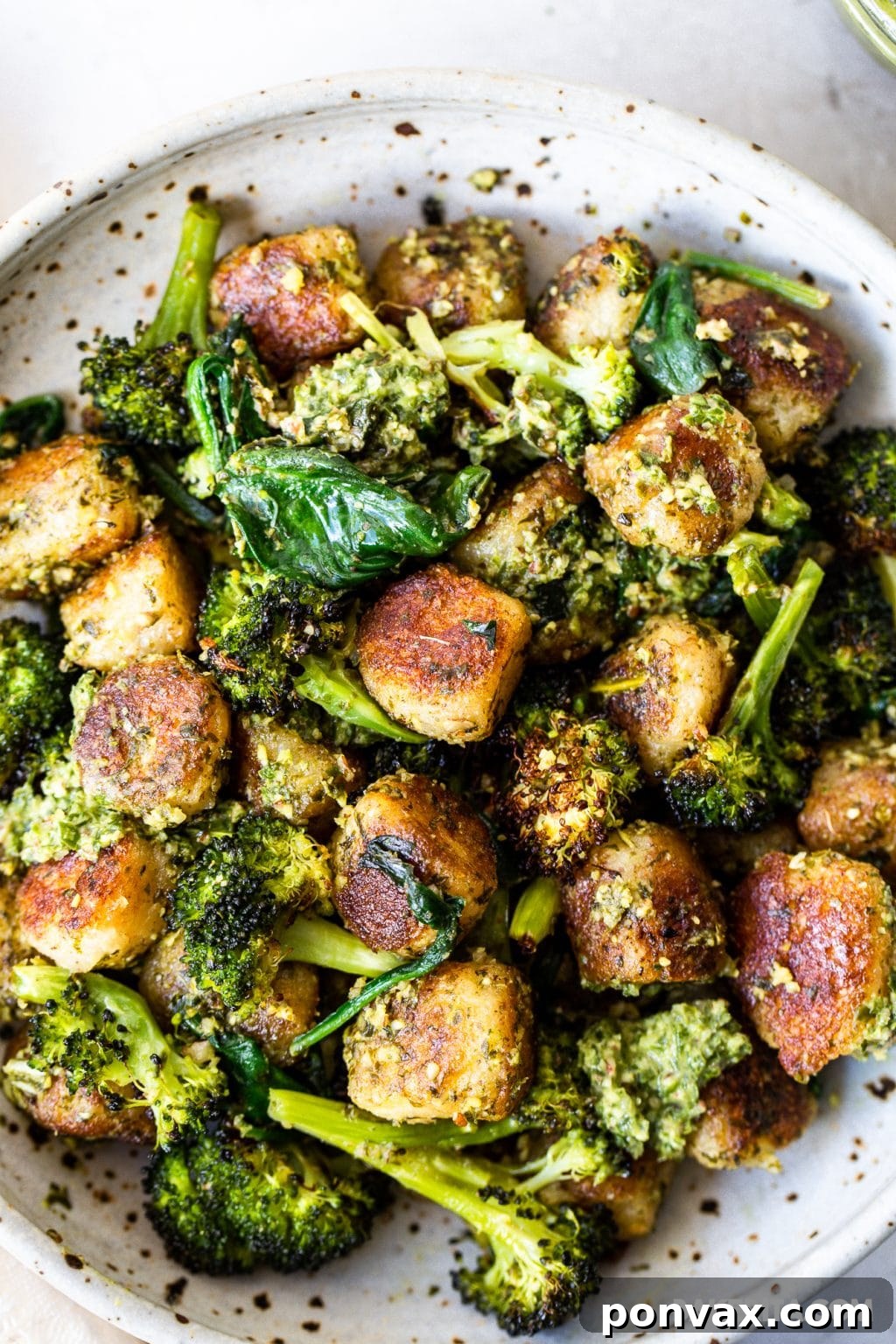 Pillowy Vegan Cauliflower Gnocchi with Fresh Pesto 3 Close-up of crispy cauliflower gnocchi in a skillet