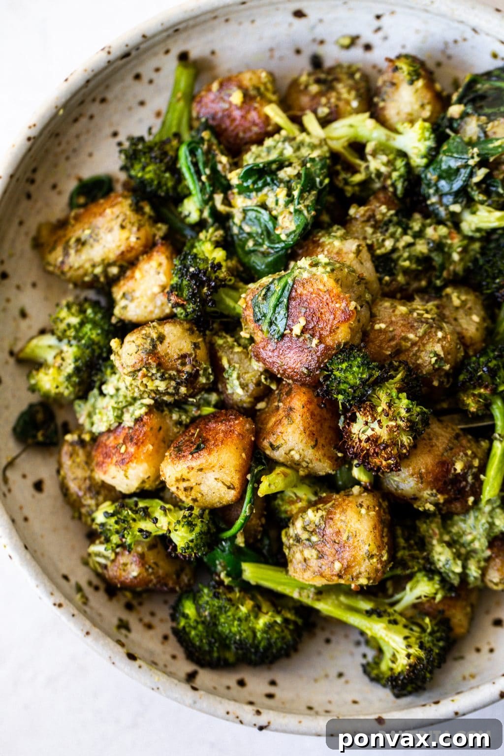 Pillowy Vegan Cauliflower Gnocchi with Fresh Pesto 6 Finished Vegan Cauliflower Gnocchi with Pesto and roasted broccoli in a pan