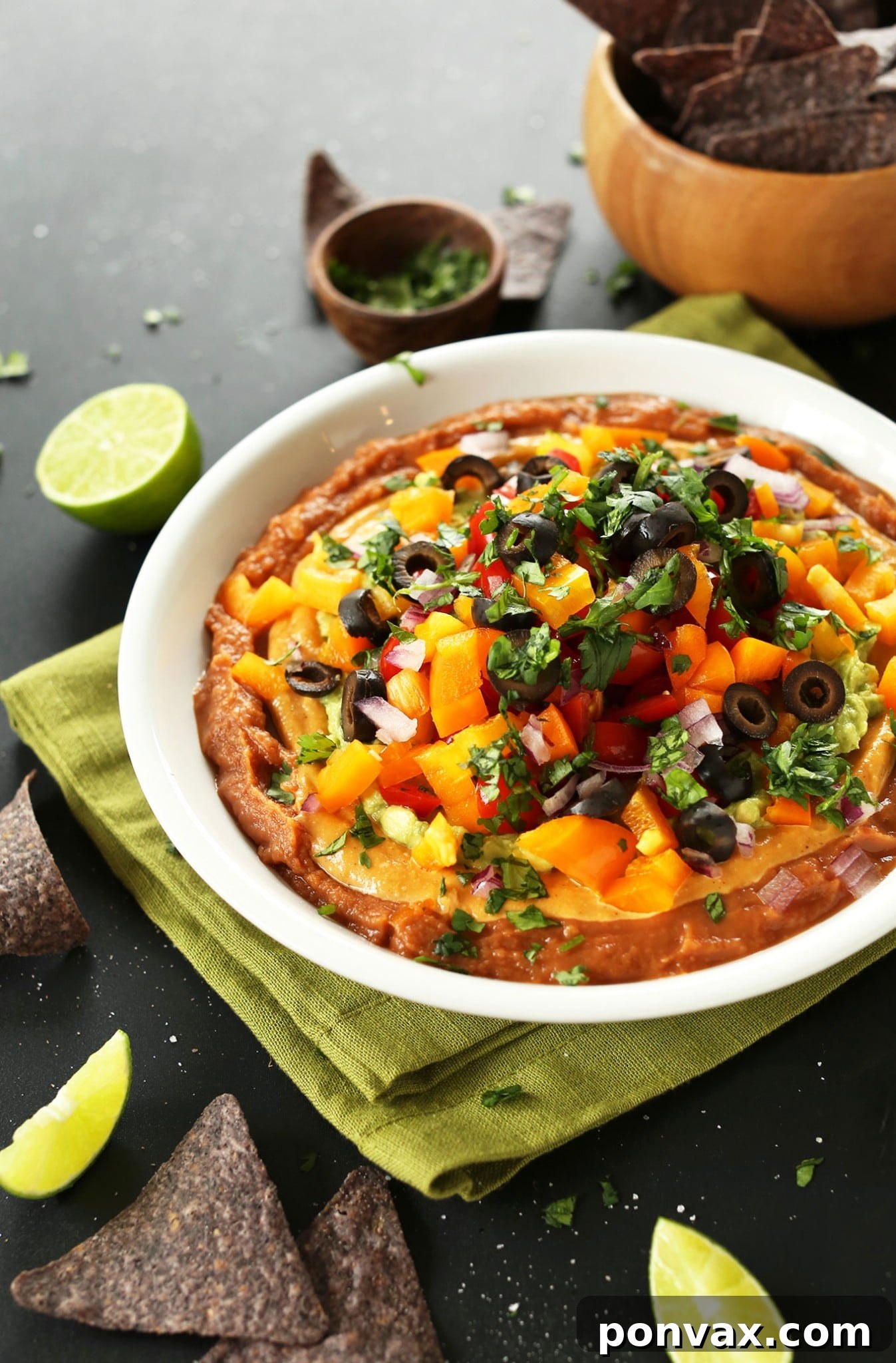 Vegan Super Bowl Feast: Over 50 Game Day Recipes 14 7-Layer Dip from Minimalist Baker, a simple, flavorful vegan game-day dip with salsa, guacamole, and vegan cheese sauce. Perfect for chips and veggies.