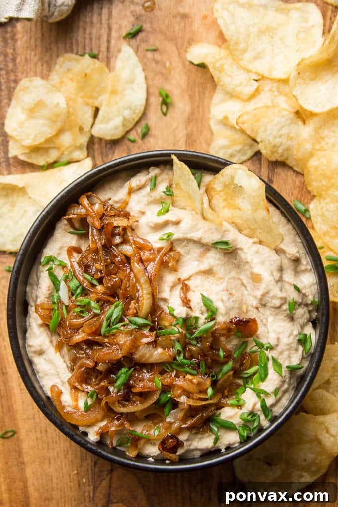 Vegan Super Bowl Feast: Over 50 Game Day Recipes 18 Vegan French Onion Dip from Connoisseurus Veg, a creamy, dairy-free cashew-based dip with caramelized onions. Perfect with chips or veggies.