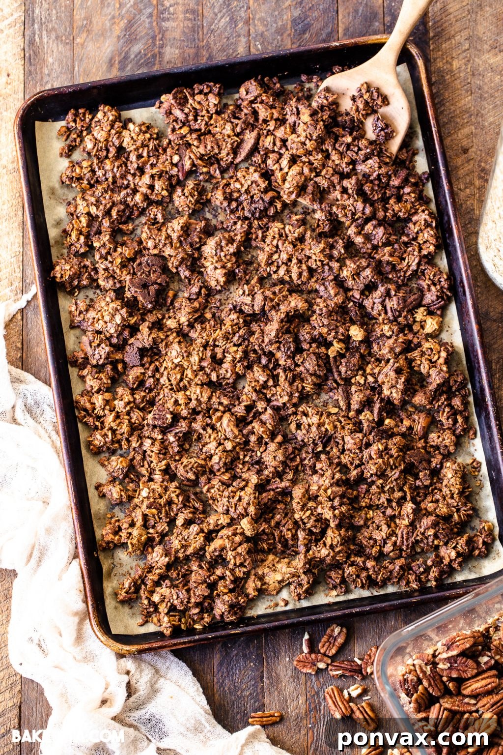 Close-up of golden brown vegan gingerbread cookie granola, sprinkled with spices, in a bowl.